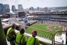 Construction workers watch the fireworks from the 18th floor of North Loop Green after Byron Buxton hit a home run in the first inning of the Twins ga