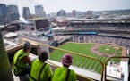 Construction workers watch the fireworks from the 18th floor of North Loop Green after Byron Buxton hit a home run in the first inning of the Twins ga