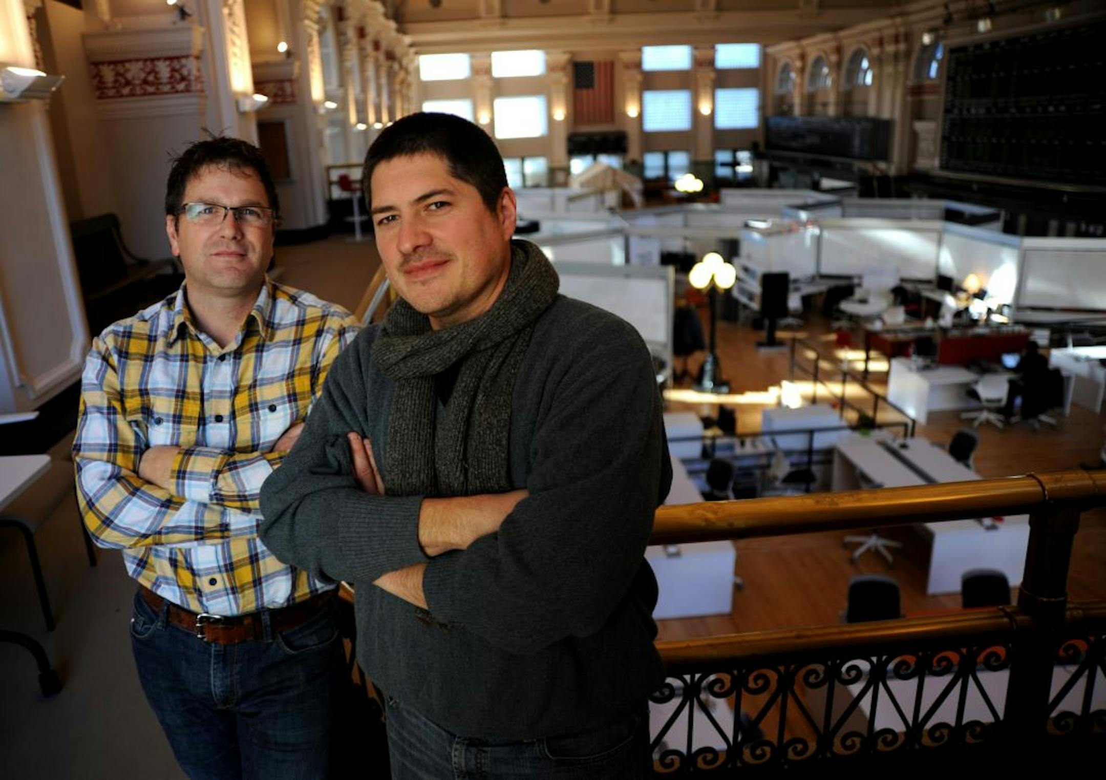 Kyle Coolbroth, left, and Don Ball are co-founders of CoCo, a business incubator that offers a collaborative work space in the Minneapolis Grain Exchange. The trading floor was abandoned when the exchange went electronic in 2008. The grand trading floor was vacant for three years until CoCo moved there.