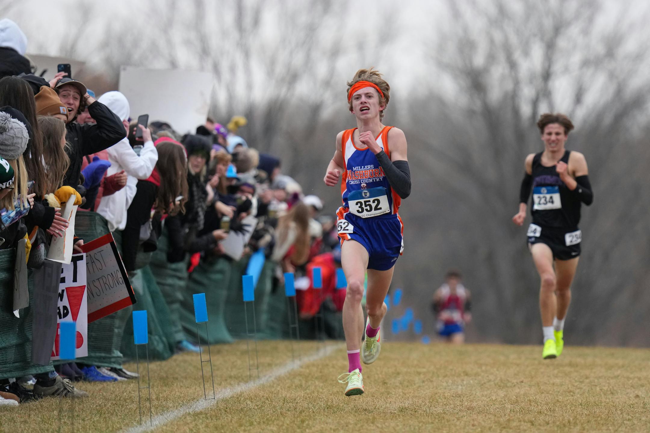 Aiden Jones, left, of Minneapolis Washburn approaches the finish line, with Sam Scott of Minneapolis Southwest behind him. Jones won the boys 3A with a time of 15:11.73. Scott came in second with a time of 15:15.30.