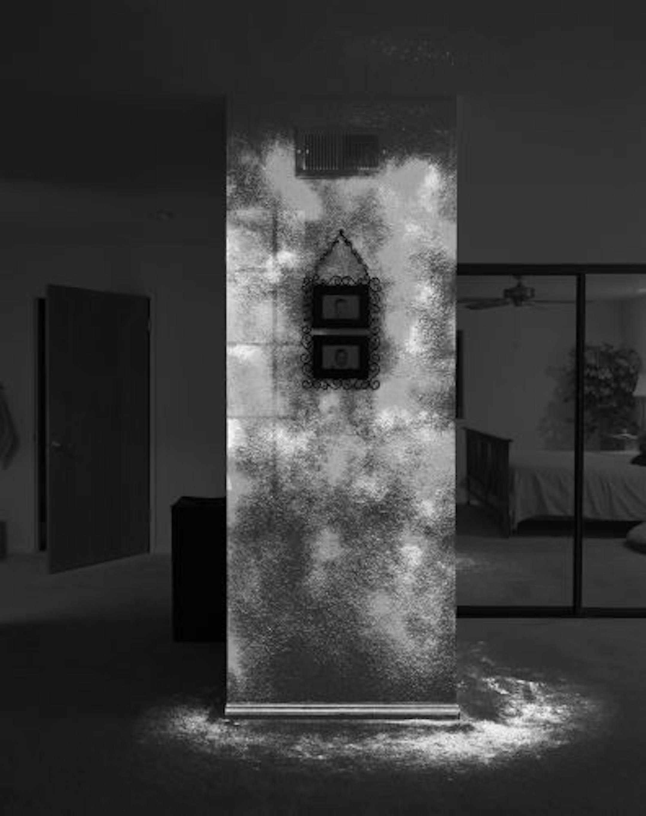 In Angela Strassheim's "Evidence No. 10 (Blue Star)," baby pictures are surrounded by a silvery mist that is actually a luminescent blood-sensitive chemical showing traces of DNA that remain from a slaying.