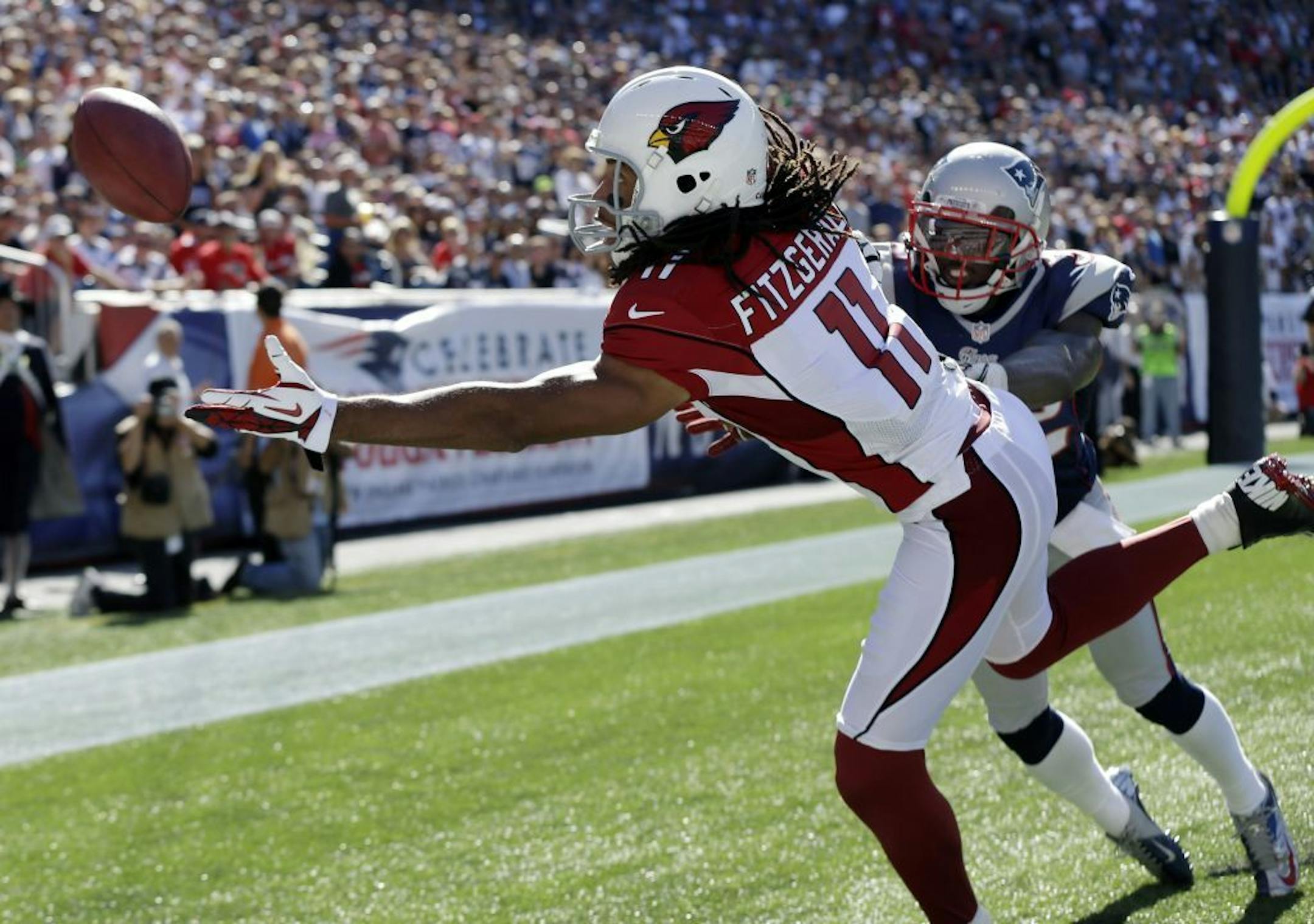 Arizona Cardinals wide receiver Larry Fitzgerald (11) cannot make a reception in the endzone against the defense of New England Patriots cornerback Devin McCourty, right, during an NFL football game at Gillette Stadium in Foxborough, Mass. Sunday, Sept. 15, 2012.
