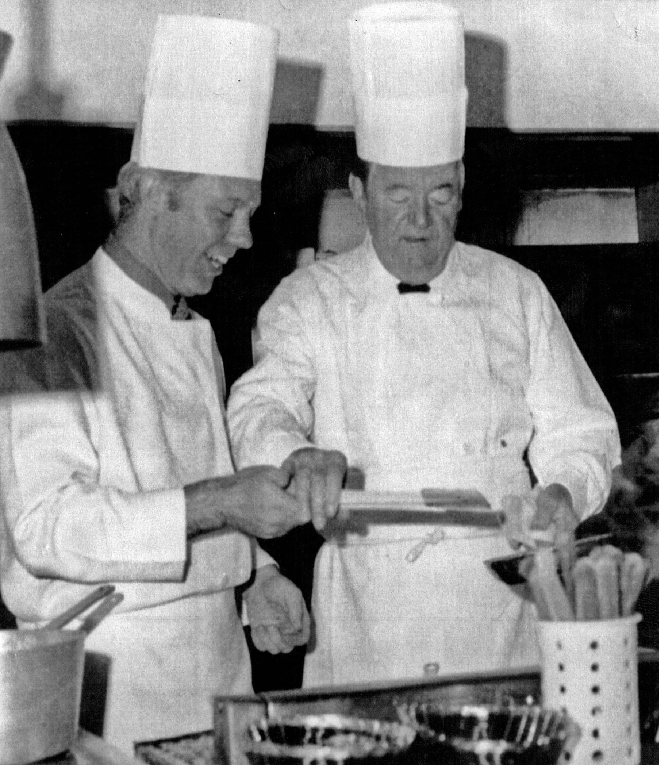 June 8, 1976 I'd Rather Do It Myself -- Minnesota Sen. Hubert Humphrey gets some help from U.S. Rep. James Oberstar, left, as he cooked omelets for 40 fellow democrats at a chalet near Duluth recently. AP Wirephoto