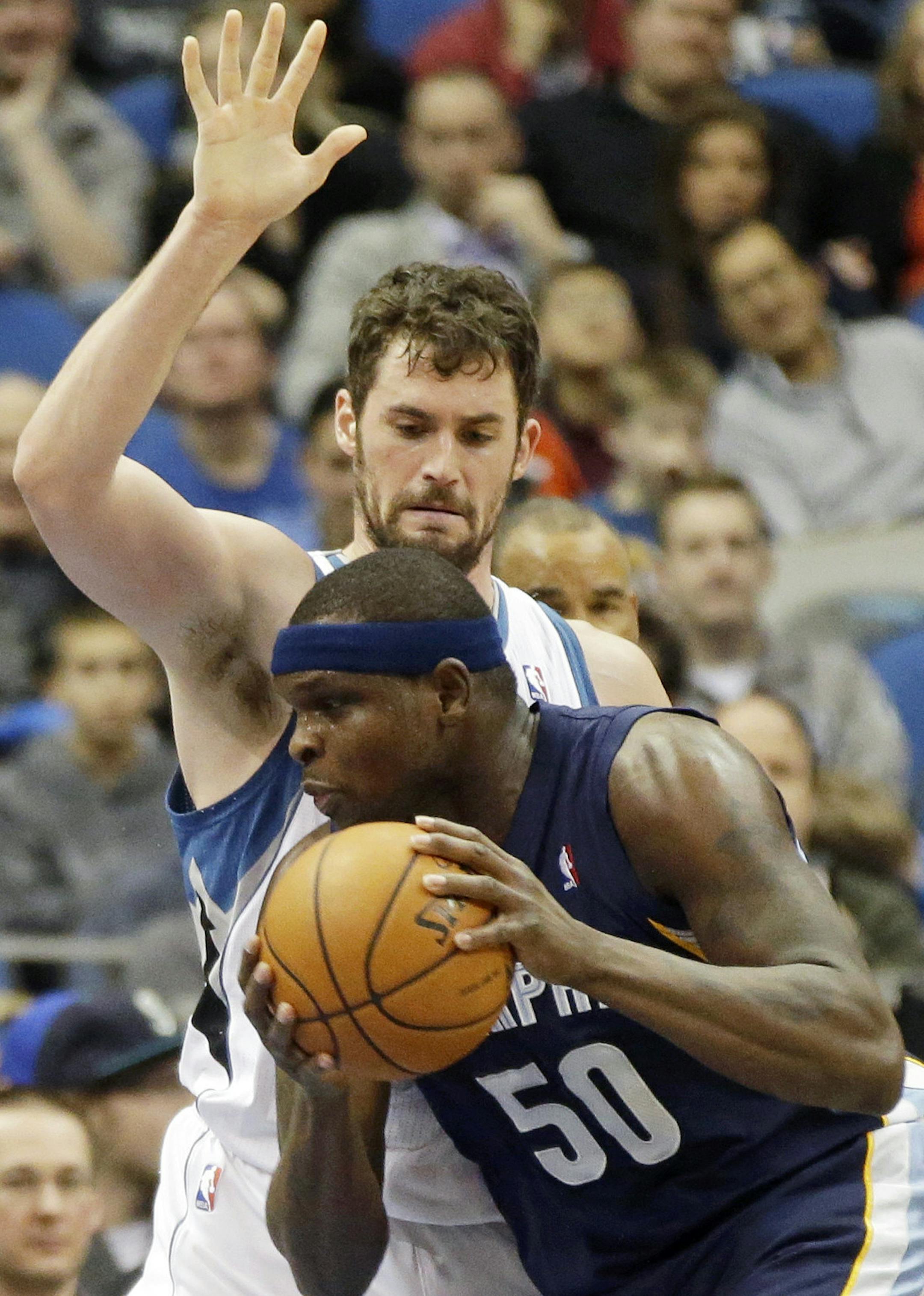 Memphis Grizzlies' Zach Randolph (50) assumes a low profile past Minnesota Timberwolves' Kevin Love in the first quarter of an NBA basketball game on Friday, Jan. 31, 2014, in Minneapolis. (AP Photo/Jim Mone)