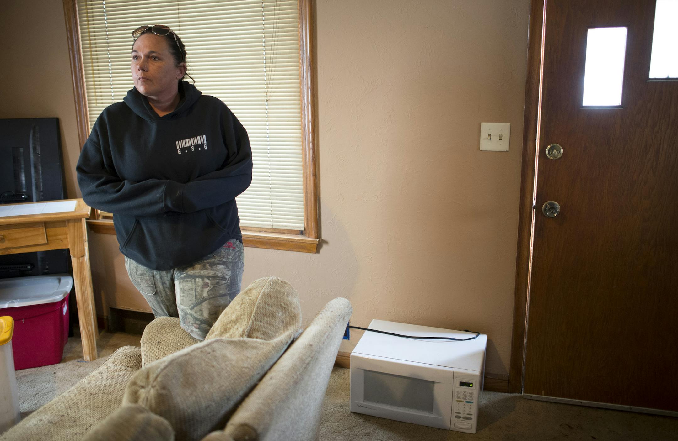 Lisa Snidarich stands in the living room of her rented home in South St. Paul. Due to bad wiring in the kitchen, Snidarich and other tenants in the home use their microwave on the living room floor. ] (Aaron Lavinsky | StarTribune) Lisa Snidarich needed a place to live, fast. She was getting divorced and has four kids. So when William Bernier said he would clean up a South St. Paul home, she believed him. Months later, Snidarich said she's living a nightmare. Bernier, who is illegally renting th