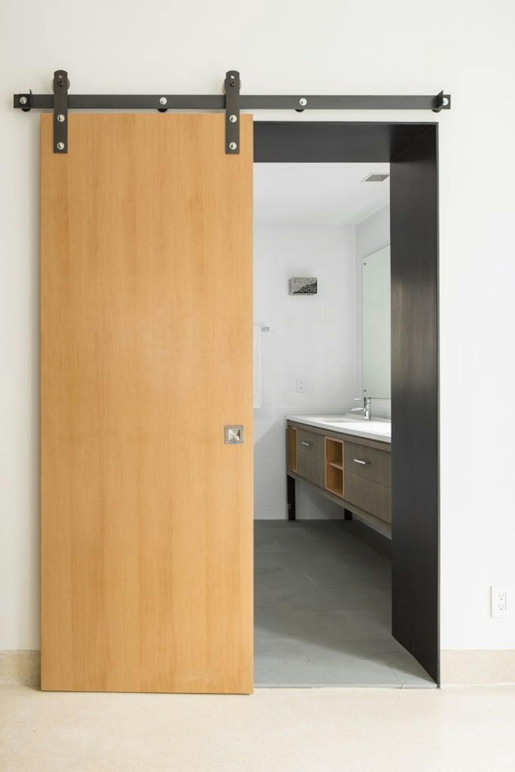 A sliding door opens to the updated and refreshed bathroom.