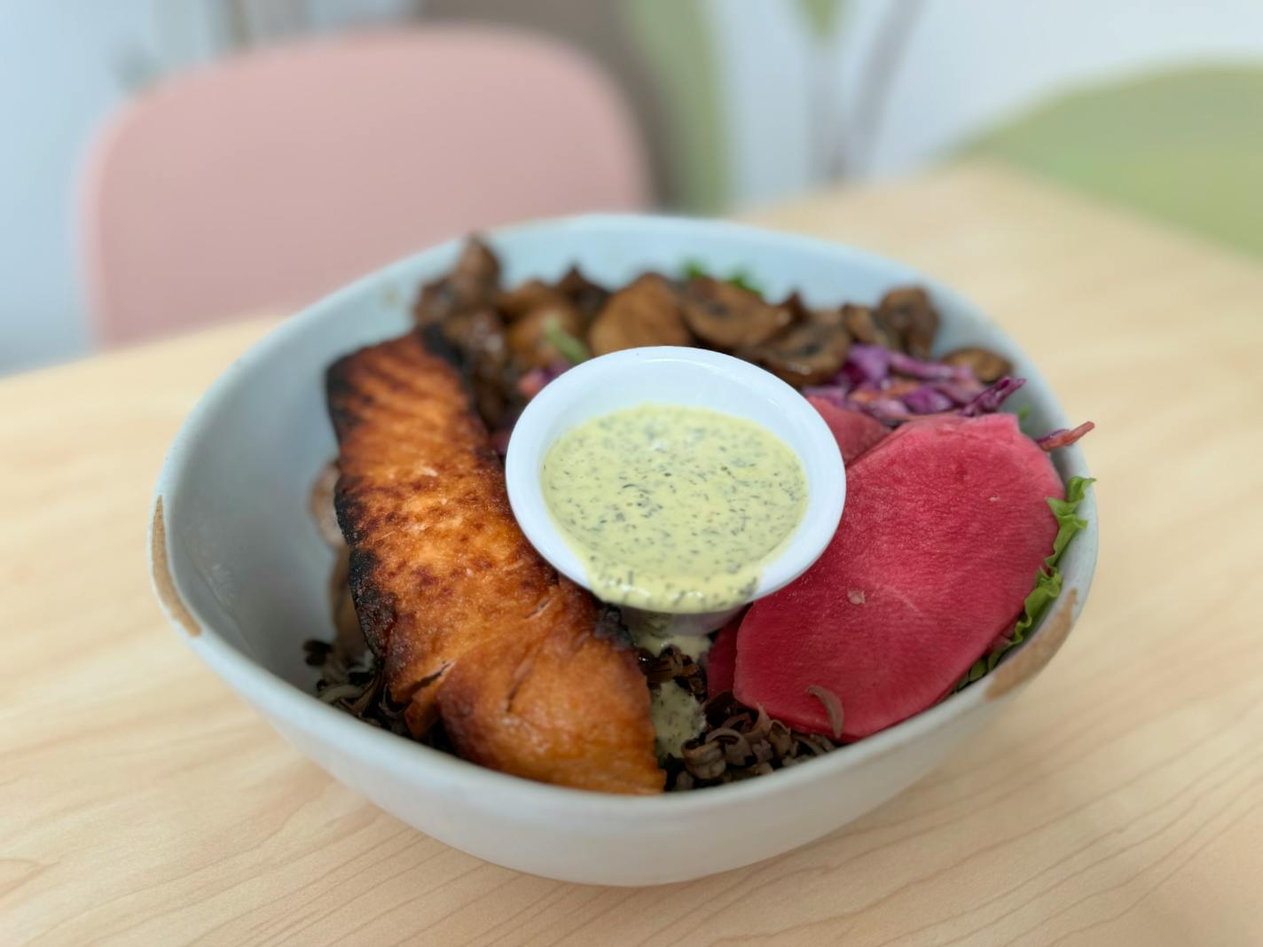 Brim in Minneapolis' Uptown features farm-to-table, organic fare including a salmon and dill bowl with wild rice, miso mushrooms and slaw in a cashew dill sauce.