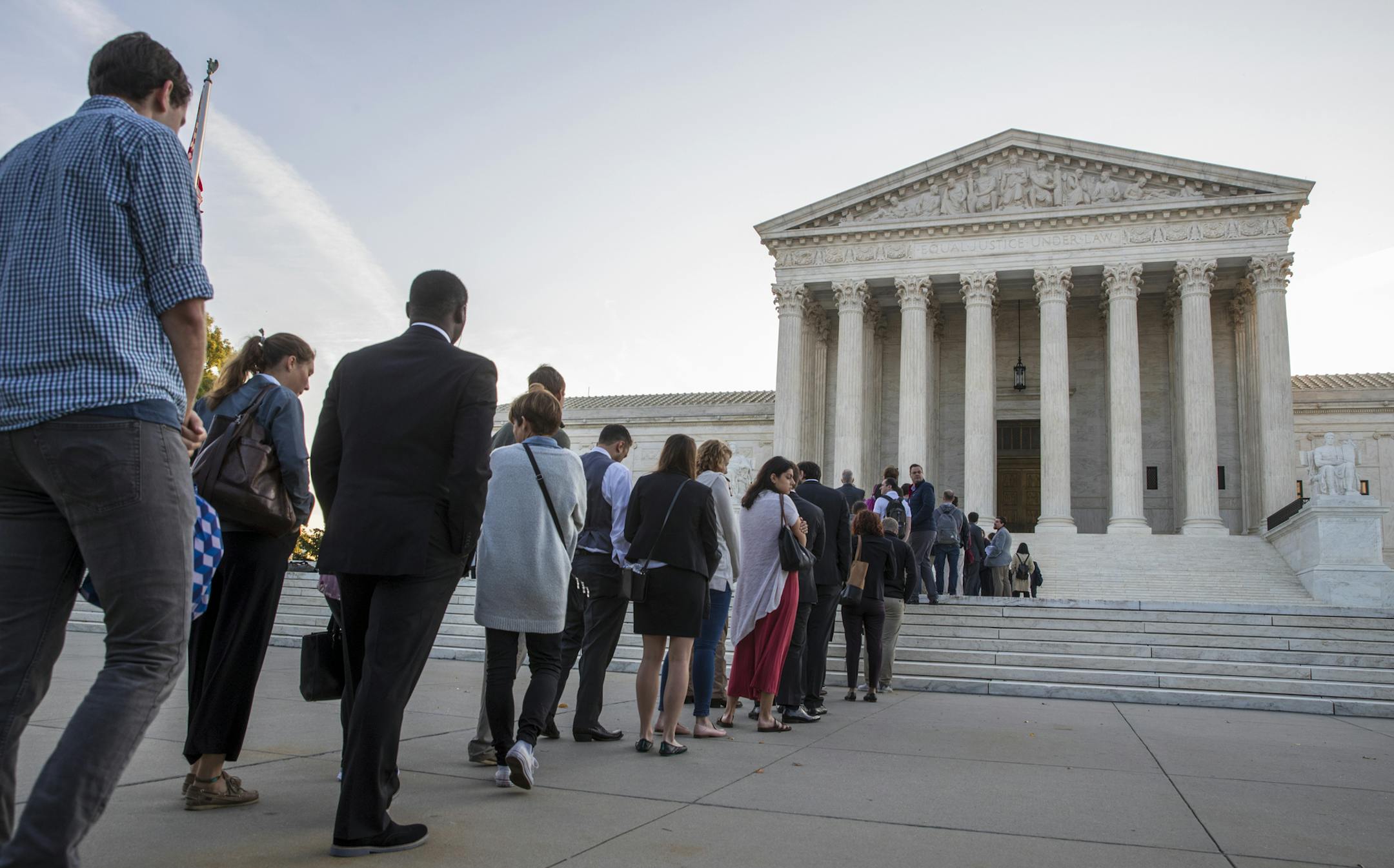 People line up at the Supreme Court on the first day of the new term, on Capitol Hill in Washington, Monday, Oct. 1, 2018. Amid the political chaos of Judge Brett Kavanaugh's nomination, the high court's work begins with only eight justices on the bench, four conservatives and four liberals. (AP Photo/J. Scott Applewhite)