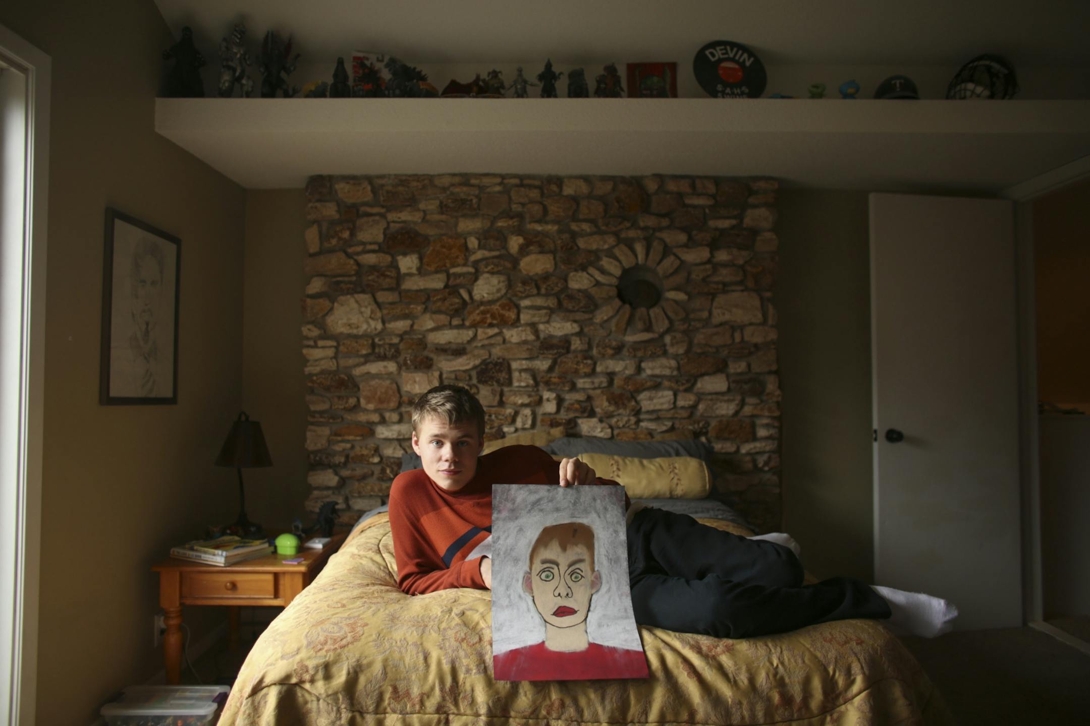 A gifted artist, Devin Wildes held up a self-portrait he did in chalk in his bedroom of his family's Oak Park Heights home Tuesday afternoon. His room is in a quiet part of the house with lots of natural light, high ceilings and a neutral color palate.
