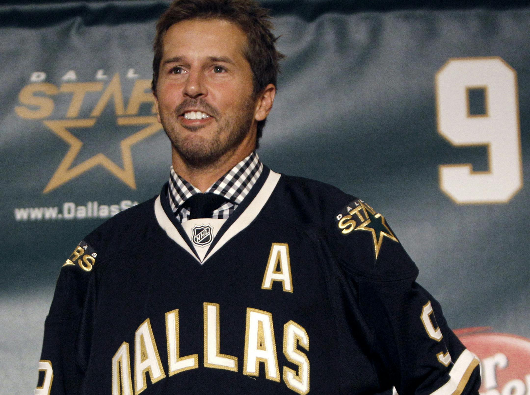 FILE - In this Sept. 23, 2011, file photo, NHL hockey player Mike Modano wears a Dallas Stars jersey during a news conference announcing his retirement in Dallas. Modano had several tearful farewells as his playing days wound down. The guy who made hockey cool in Dallas figures he'll get emotional again for the final ceremony: retiring his iconic No. 9 during the Stars' game against Minnesota on Saturday, March 8. (AP Photo/LM Otero, File)