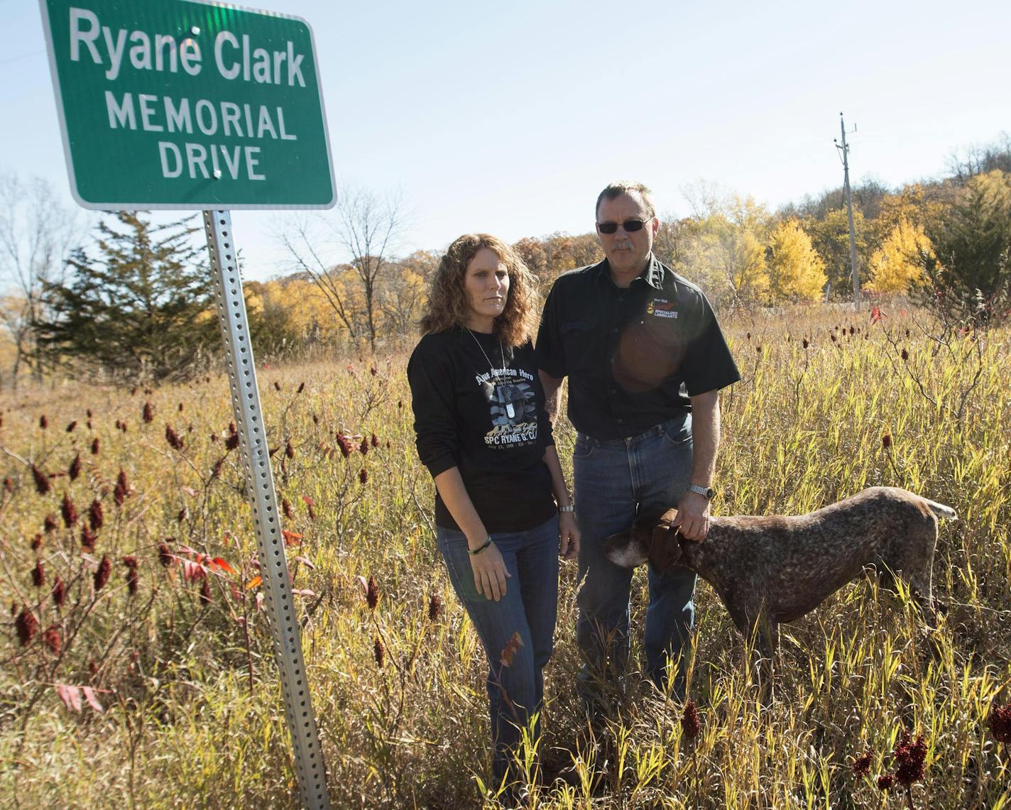 Tracy and Ricky Clark survey the land they hope will be used to construct a parking lot for a nearby state trail in honor of their son, Ryane, who died four years ago in Afghanistan. Accompanying them is Ryane's dog, Ozzie.