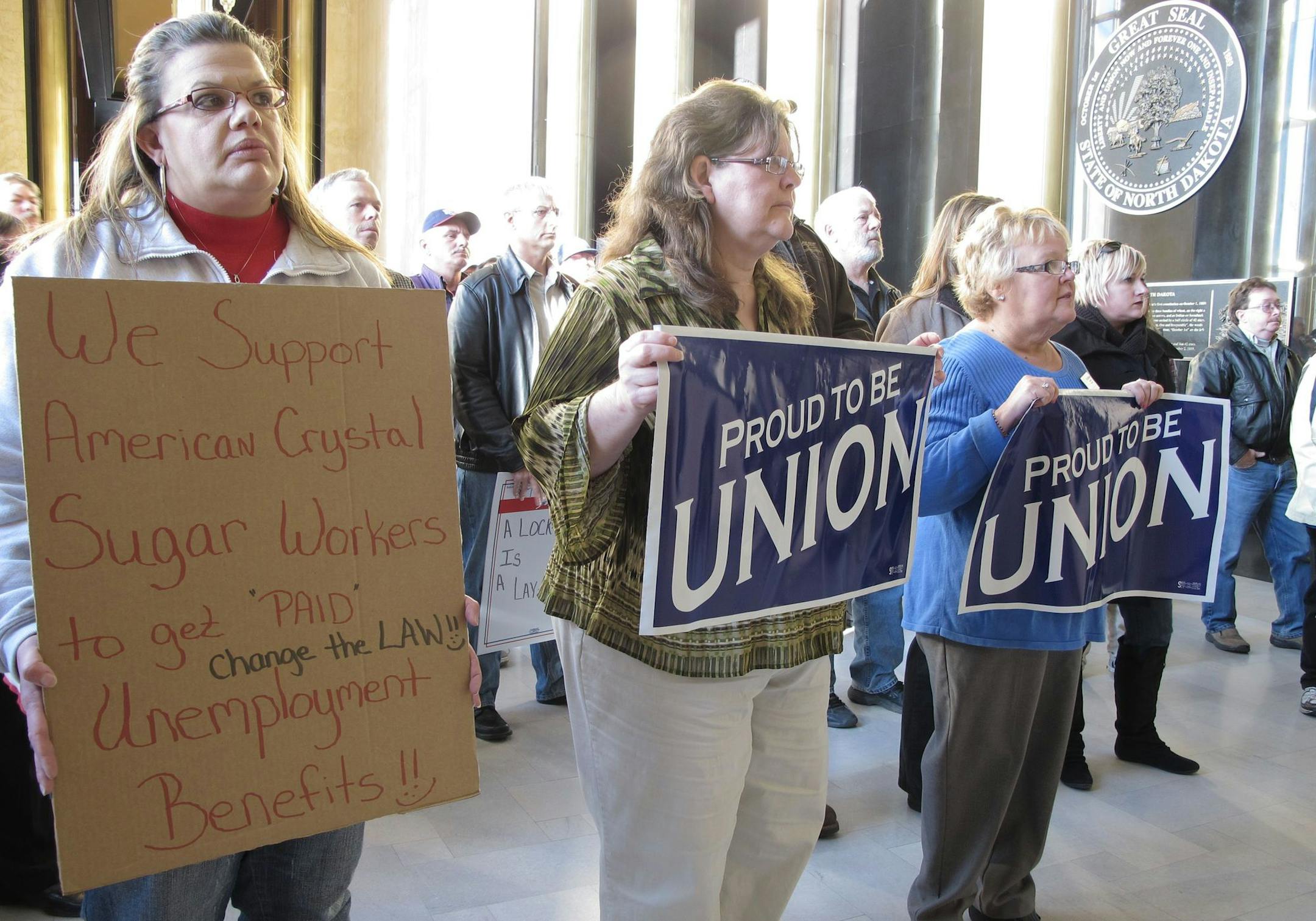 Supporters of American Crystal Sugar Co. workers, who have been locked out of the company's sugar beet processing plants since Aug. 1, rally in the North Dakota Capitol in Bismarck on Wednesday, Nov. 9, 2011, to support legislation that would allow the locked-out workers to receive unemployment benefits. On Monday, a Senate committee declined to allow introduction of a bill that would have allowed the workers to apply for benefits. About 400 North Dakota workers are affected by the lockout, whic