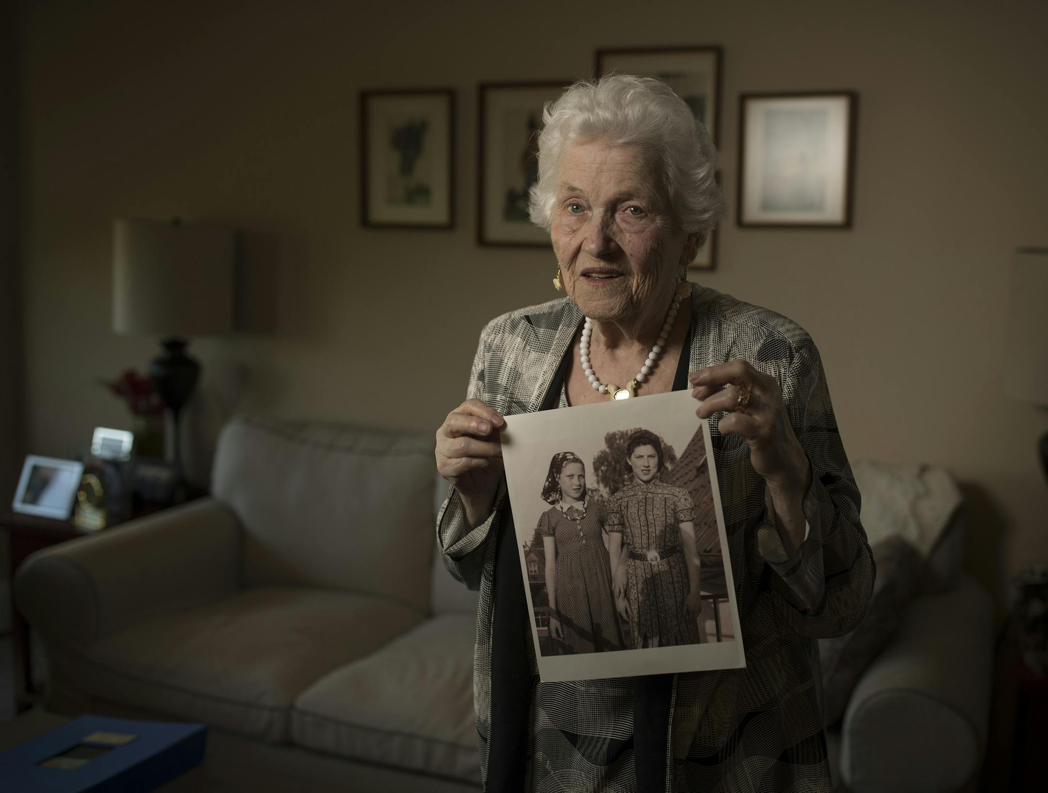 Holocaust survivor Judy Meisel held a photo of herself and her sister that was taken in 1946 in Demark after she was liberated. Judy at left in the picture was 16, and her sister Rachel Levitin was 19,Monday July 3, 2017 in St. Louis Park, MN. ] JERRY HOLT • jerry.holt@startribune.com