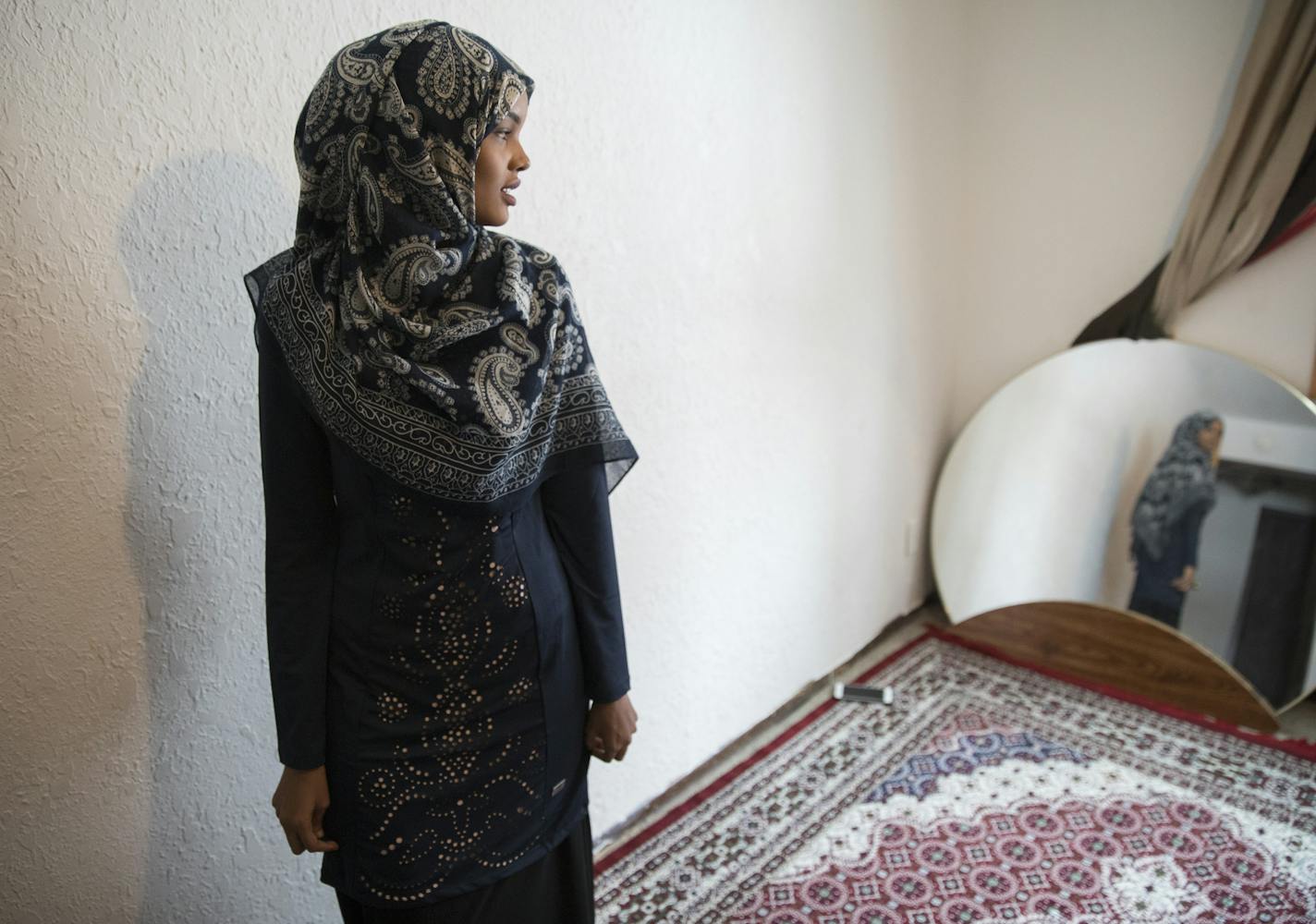 Halima Aden tries on the burkini she will wear for the Miss Minnesota pageant at home in Waite Park. At her mother's request, she added a long skirt to cover the pants of the burkini, which her mother thought immodest. ] (Leila Navidi/Star Tribune) leila.navidi@startribune.com BACKGROUND INFORMATION: At home with Halima Aden in Waite Park on Wednesday, November 23, 2016. Somali-American Halima Aden, 19, will become the first woman to compete for the title of Miss Minnesota USA while wearing a bu