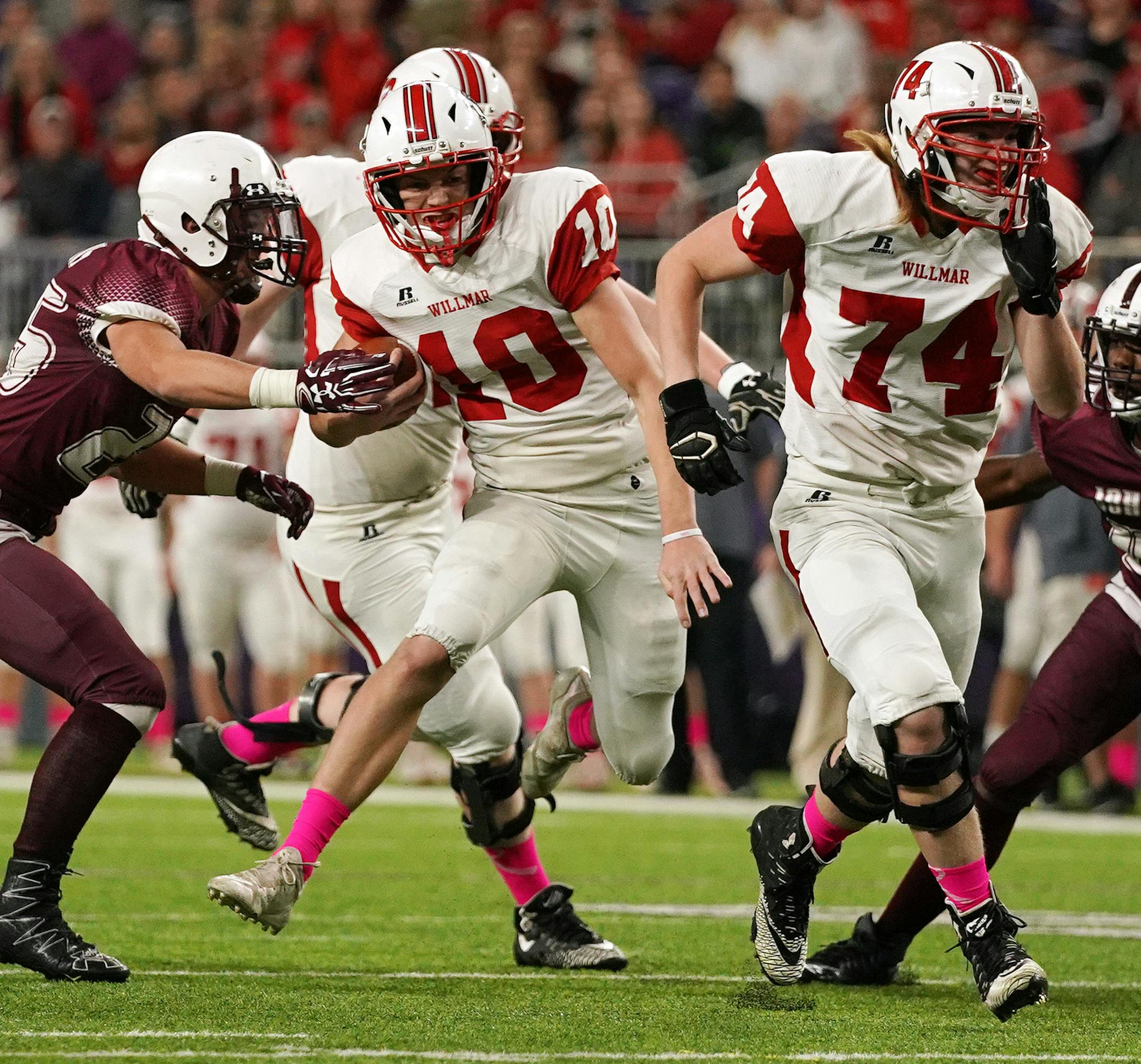 Willmar quarterback Drey Dirksen (10) sprinted past the St. Paul Johnson defense with the ball as St. Paul Johnson defensive end Samuel Kray (25) tried to make the stop in the first half. ] ANTHONY SOUFFLE ï anthony.souffle@startribune.com Willmar High School played St. Paul Johnson High School in a Class 4A MSHSL football semifinal game Friday, Nov. 16, 2018 at U.S. Bank Stadium in Minneapolis.