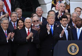 From left, Senate Majority Leader Mitch McConnell of Ky., Vice President Mike Pence and President Donald Trump applaud as House Speaker Paul Ryan of W