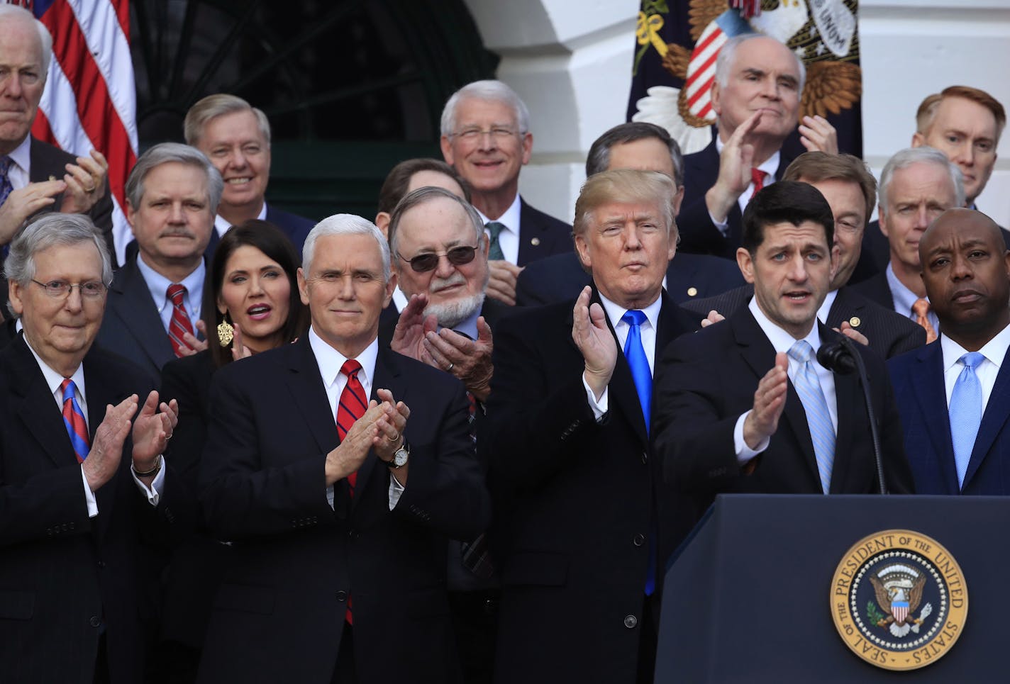 From left, Senate Majority Leader Mitch McConnell of Ky., Vice President Mike Pence and President Donald Trump applaud as House Speaker Paul Ryan of Wis., speaks about the passage of the tax bill at the White House in Washington, Wednesday, Dec. 20, 2017. (AP Photo/Manuel Balce Ceneta)