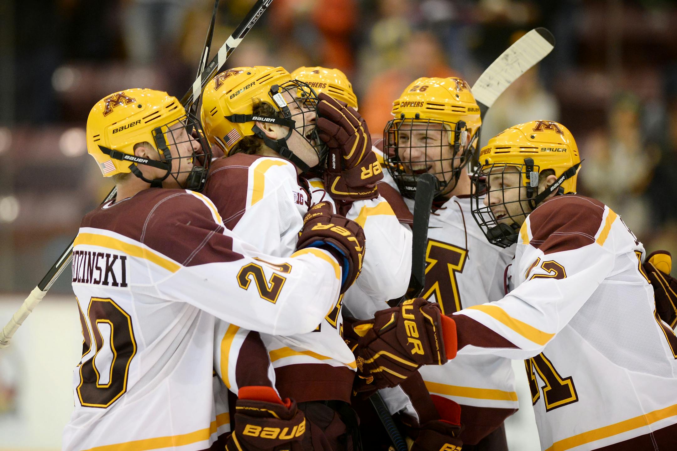 FILE - Teammates celebrated around University of Minnesota left wing Brent Gates Jr., (10) after his first career goal as a Gopher last weekend. Minnesota won its first game of the season Friday.