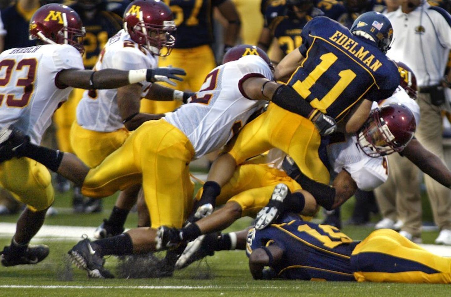 The Gophers defense pulls down Kent State quarterback Julian Edelman during the first half of Edelman's first game at Kent State in 2006. Minnesota won 44-0.