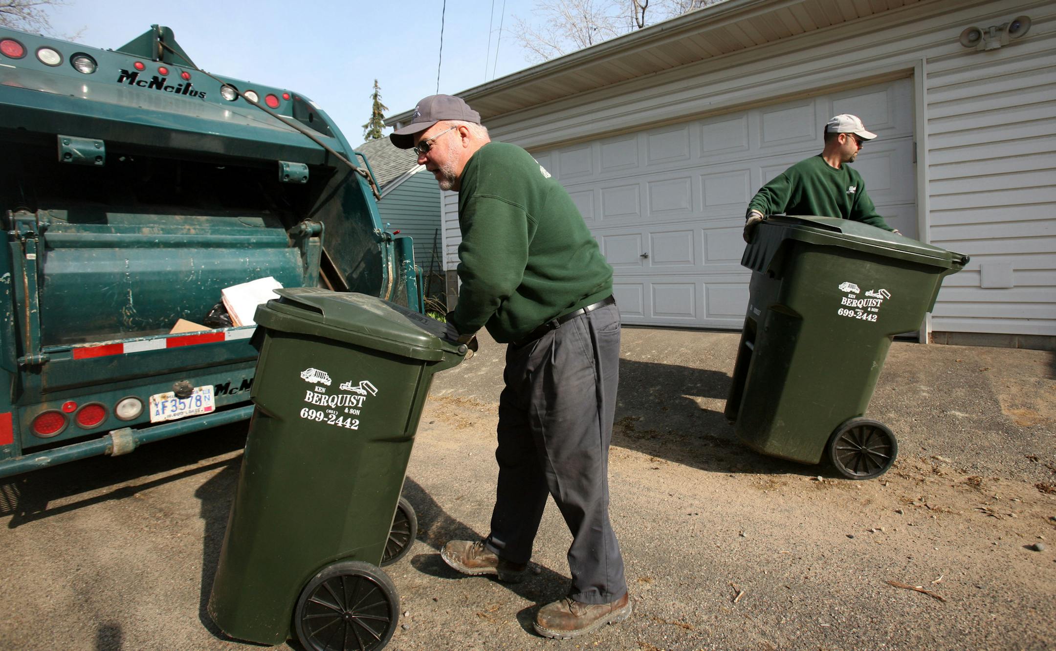 KYNDELL HARKNESS &#xef; kharkness@startribune.com Jim Berquist wheeled a trash can toward the back of the garbage truck while his son Mike put one back in it's place during their route in St. Paul. This alley between Sargent and Princeton one neighbor, Todd Seabury-Kolod, got his neighbors to get the same garbage company.