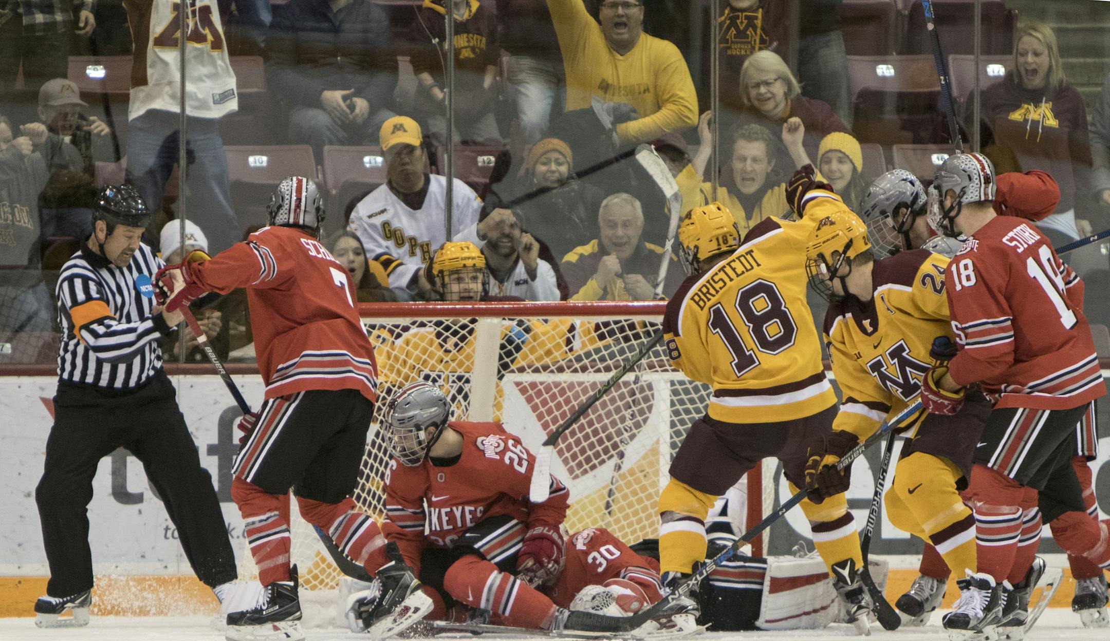 Minnesota Golden Gophers forward Leon Bristedt (18)sneaks the puck past Ohio State Buckeyes goalie Christian Frey (30) for the game winning goal, 1:21 into overtime. The Minnesota Golden Gophers defeat the Ohio State Buckeyes at Mariucci Arena in Big Ten Conference action on December 5, 2015. ] Special to Star Tribune MATT BLEWETT ï matt@mattebphoto.com - December 5, 2015, Minneapolis, MN, Big Ten Hockey, Minnesota Golden Gophers vs. Ohio State Buckeyes, 753323 UPUK 120615