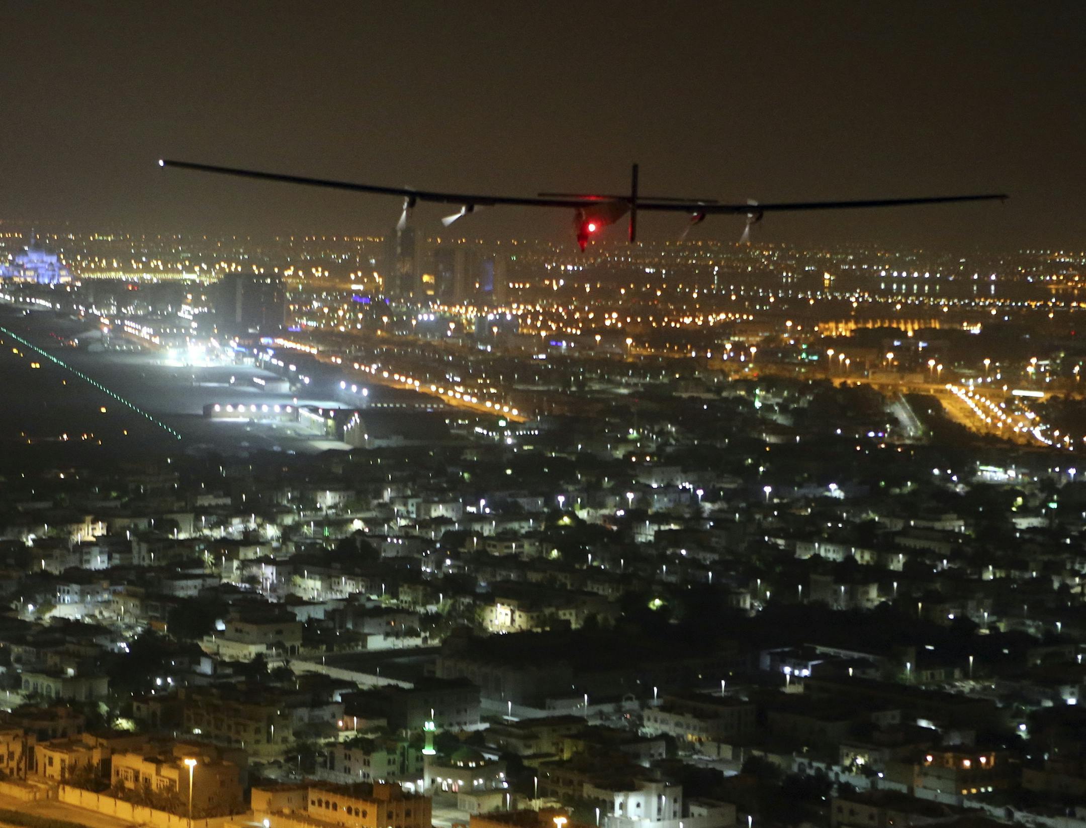 The Solar Impulse 2 plane approaches to land at Al Bateen Executive Airport in Abu Dhabi, United Arab Emirates, on Tuesday, July 26, 2016. The world’s first ever round-the-world flight to be powered solely by the sun’s energy made history with its landing in the Emirati capital, where it first took off on an epic 22,000-mile (35,000 kilometer) journey more than a year ago (AP Photo/Adam Schreck)