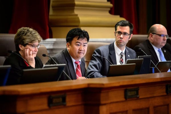 Council Member Blong Yang spoke to repeal of the spitting and lurking laws. Barb Johnson, left, was the lone vote against repeal. On the right are Cou
