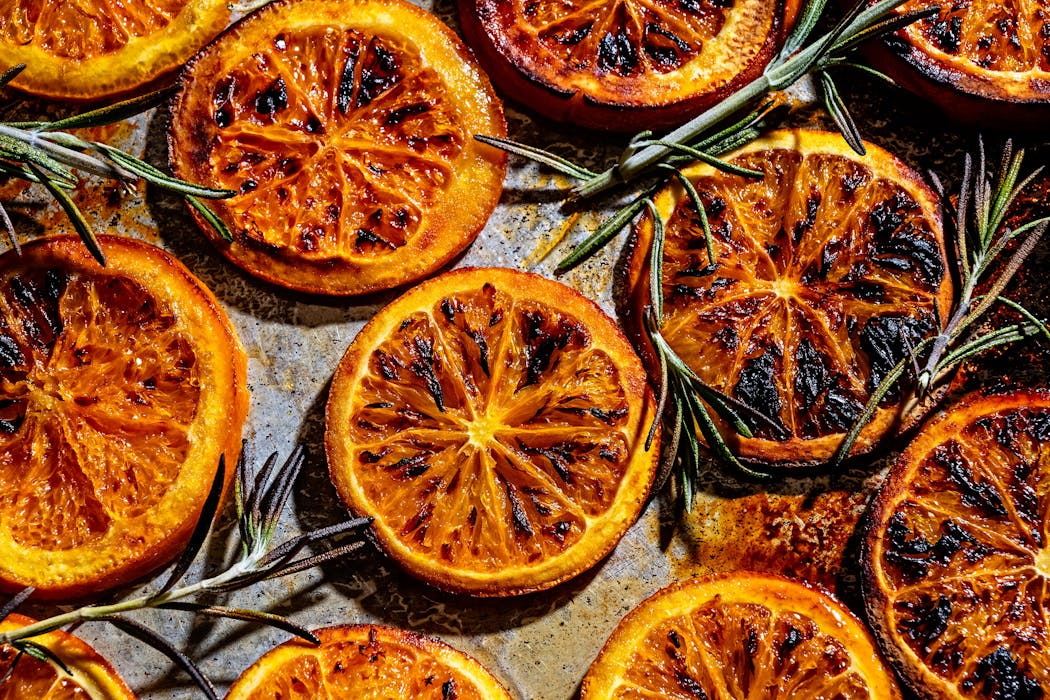 Broiled orange slices and rosemary sprigs blend to make Burnt Orange Tonic with Rosemary.