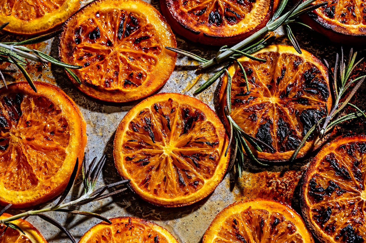 Broiled orange slices and rosemary sprigs blend to make Burnt Orange Tonic with Rosemary.