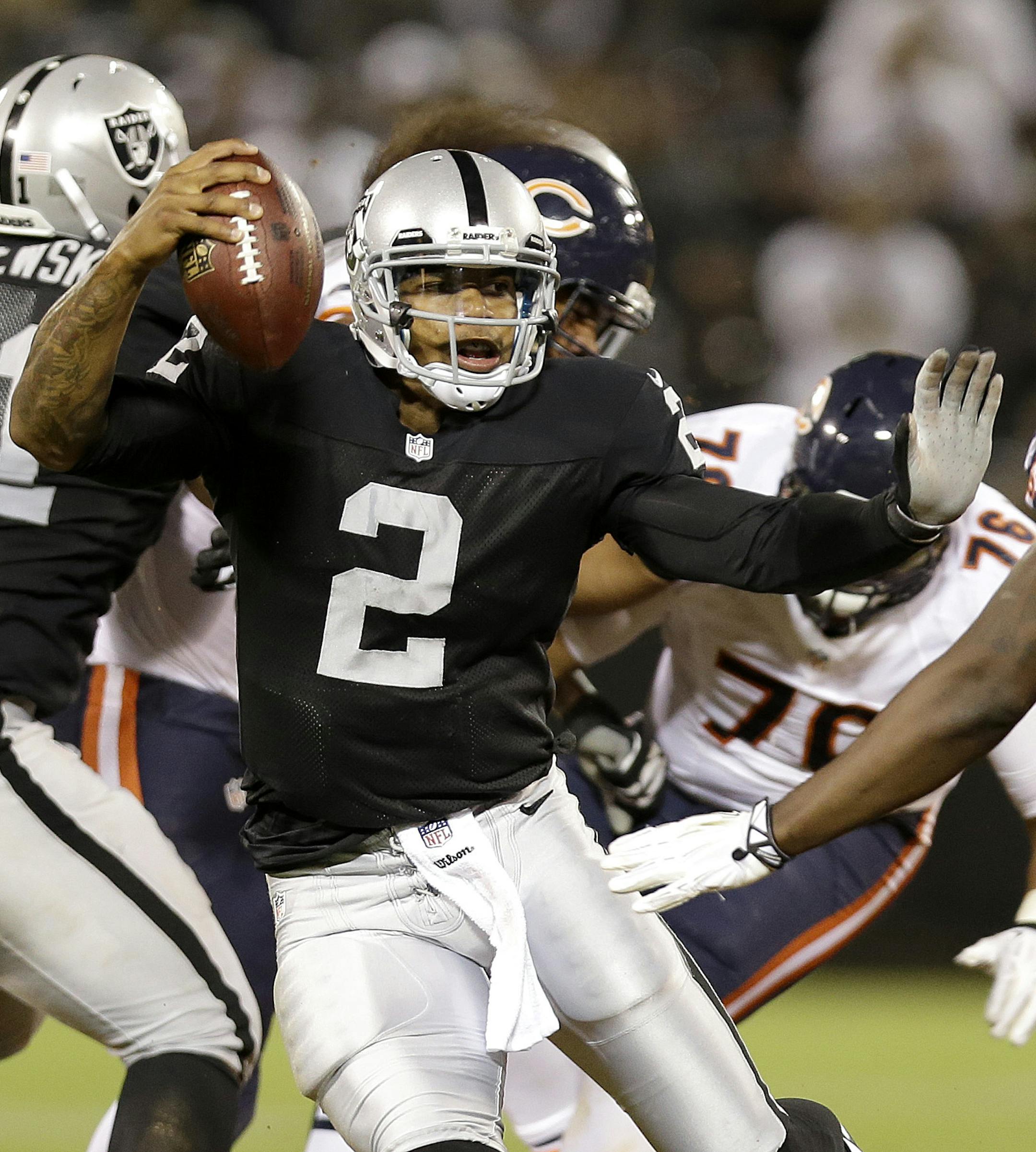 Oakland Raiders quarterback Terrelle Pryor (2) avoids Chicago Bears defensive end Kyle Moore (96) on his 25-yard touchdown run during the third quarter of an NFL preseason football game in Oakland, Calif., Friday, Aug. 23, 2013. (AP Photo/Marcio Jose Sanchez) ORG XMIT: MIN2013090620502621