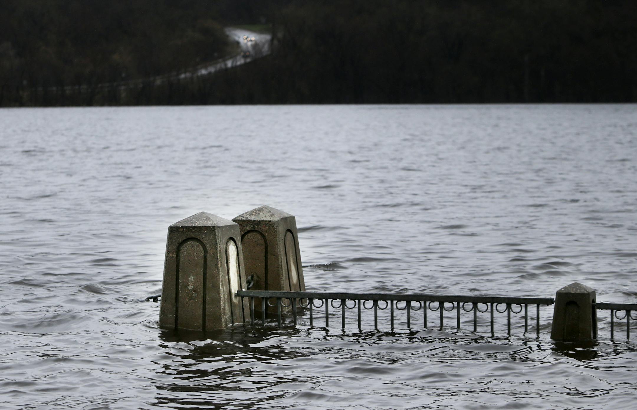 Rain has also caused the river to spill over along a walkway in Stillwater.
