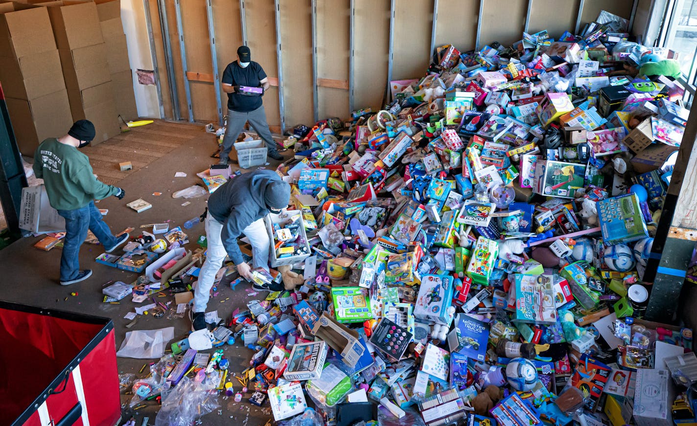 Toys for Tots volunteers worked through a huge pile of donated new toys, sorting them into bins marked for girls and boys of different ages on Wednesday.