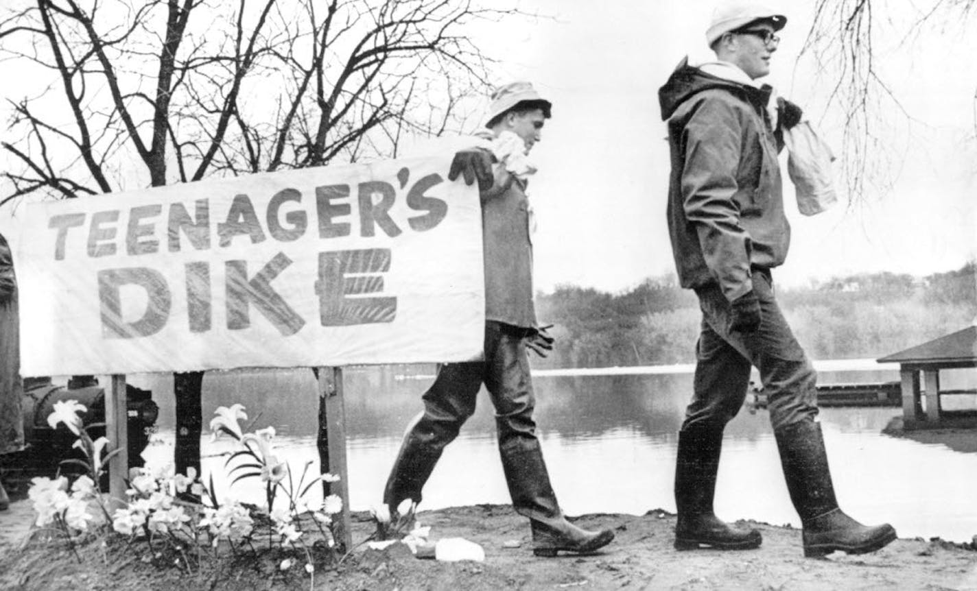 Fifteen-year-old Doug Webster, right, was one of hundreds of teenagers who carried sandbags down the levee, decorated with Easter lillies. They staked their claim to that portion of Stillwater's defense against the river.