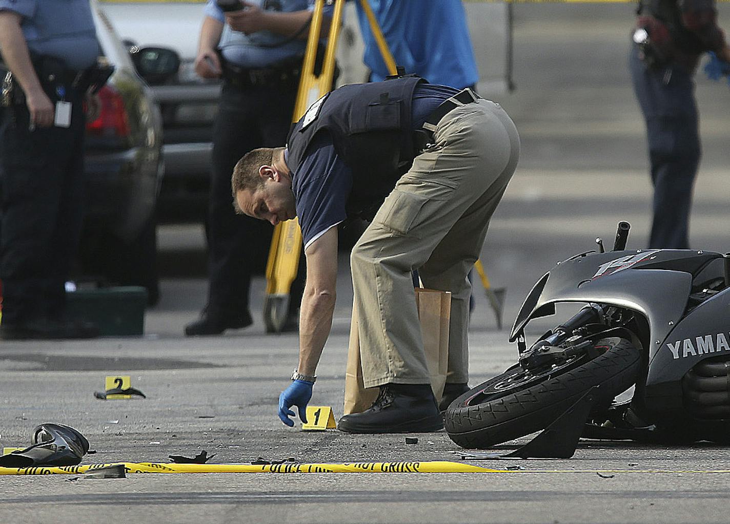 Minneapolis police officers surveyed the scene where a police vehicle and motorcycle collided at the intersection of Blaisdell and 26th in Minneapolis on Friday.