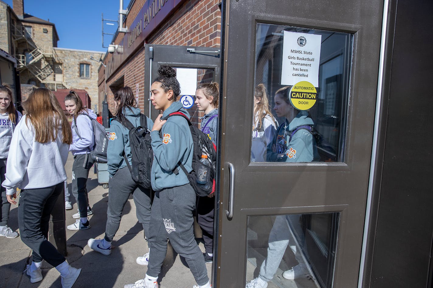 Members of the Rochester Lourdes girls' basketball team left Williams Arena after the MSHSL announced the cancellation of the state tournament on March 13, 2020