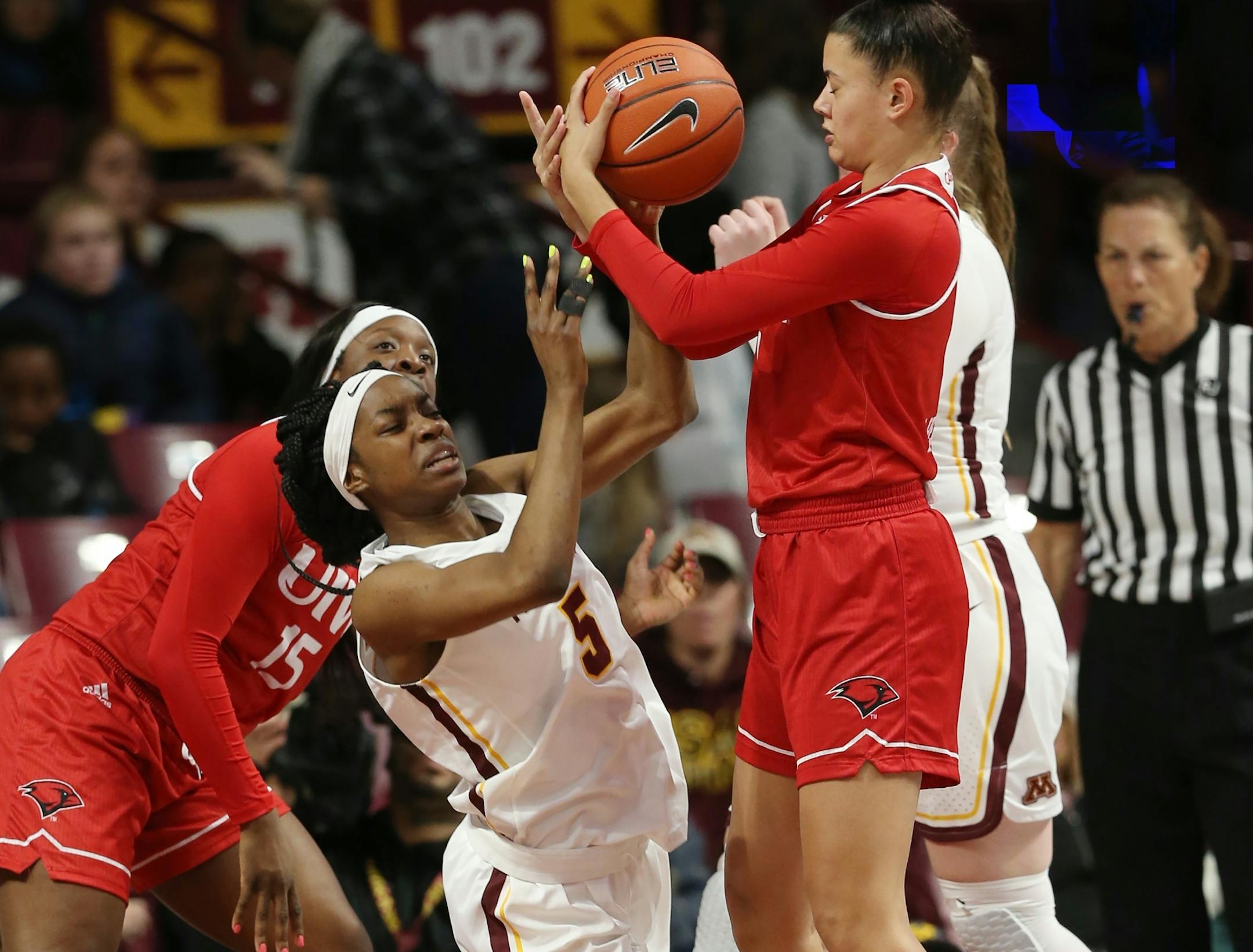 Minnesota's Taiye Bello (5) and Alexis Henry(1) fight for the ball when Minnesota played Immaculate Word earlier this month.