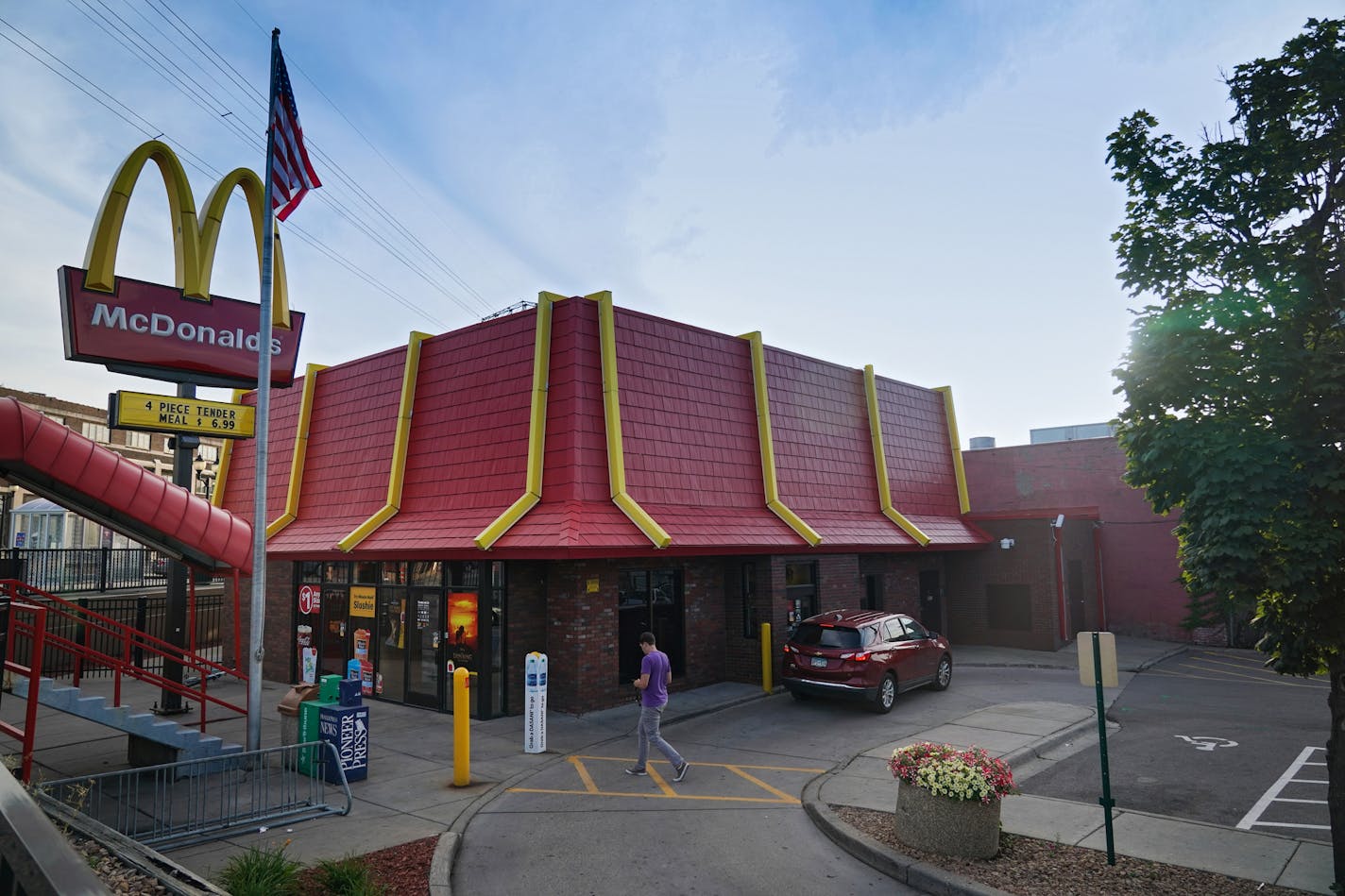 A man walks toward the McDonald's near the University of Minnesota campus in Minneapolis as a car waits at the drive-thru window. ] Shari L. Gross &#x2022; shari.gross@startribune.com A Minneapolis City Council committee vote to ban new drive-through facilities Thursday morning as part of the city's efforts to cut down vehicle traffic and hit sustainability goals.