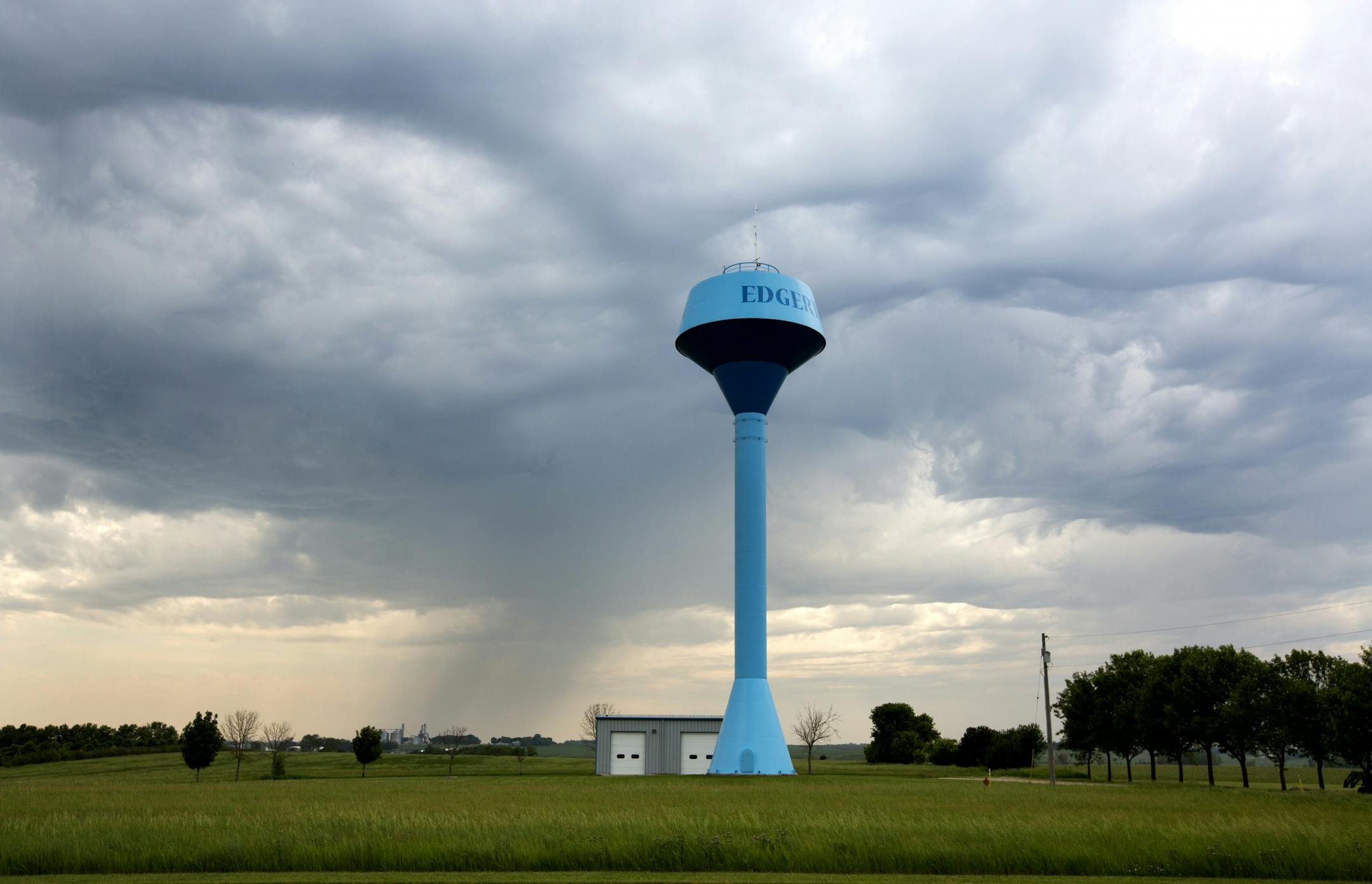 A summer rain approaches Edgerton from the west. The water tower on the north edge of town serves the farming community of 1,200 residents.
