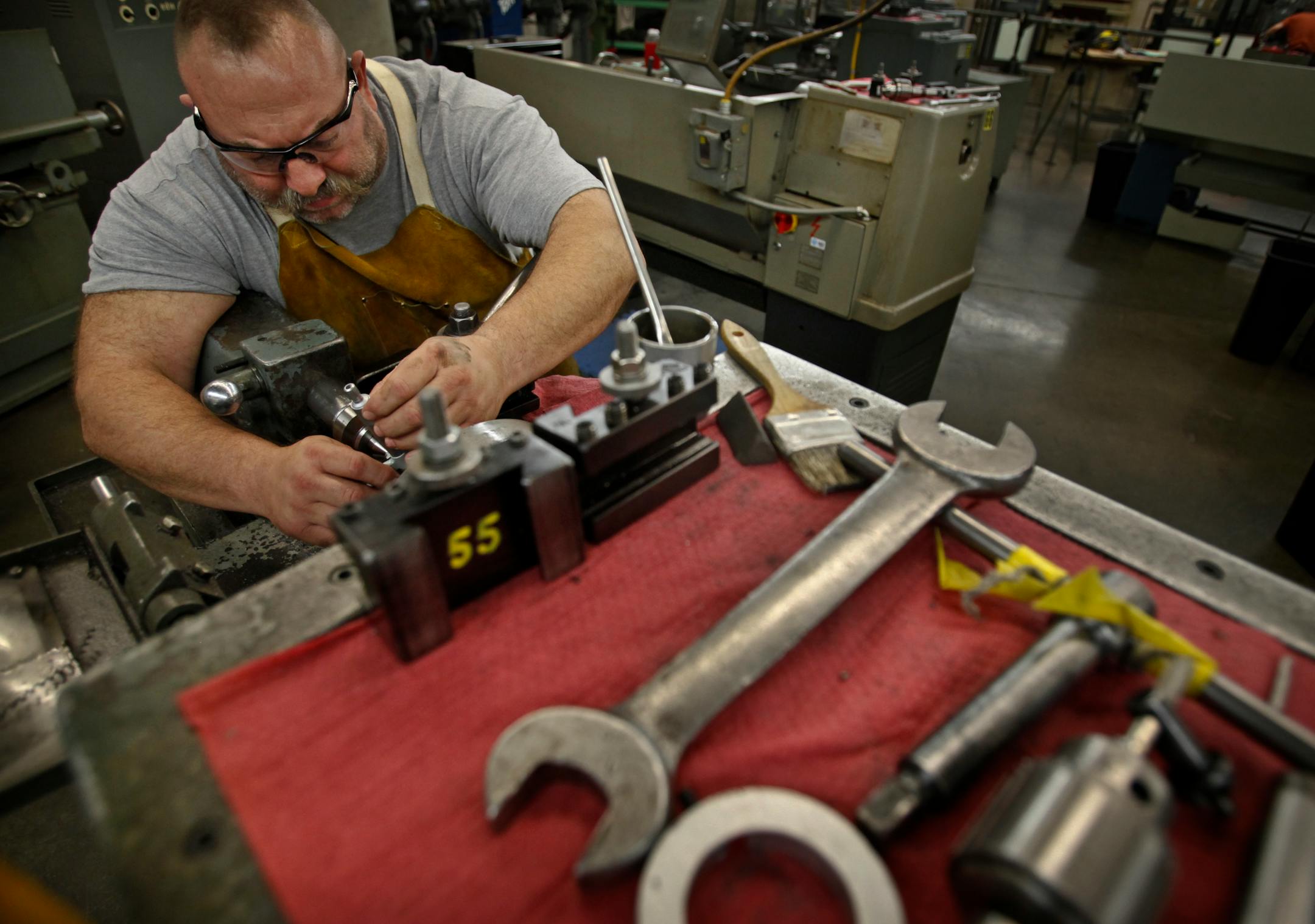 Todd Mills, a machine tool major at MCTC from Lakeville, makes minor adjustments to the settings of a metal lathe while cutting a taper in a metal cylinder during machine tool tech Tuesday at MCTC.