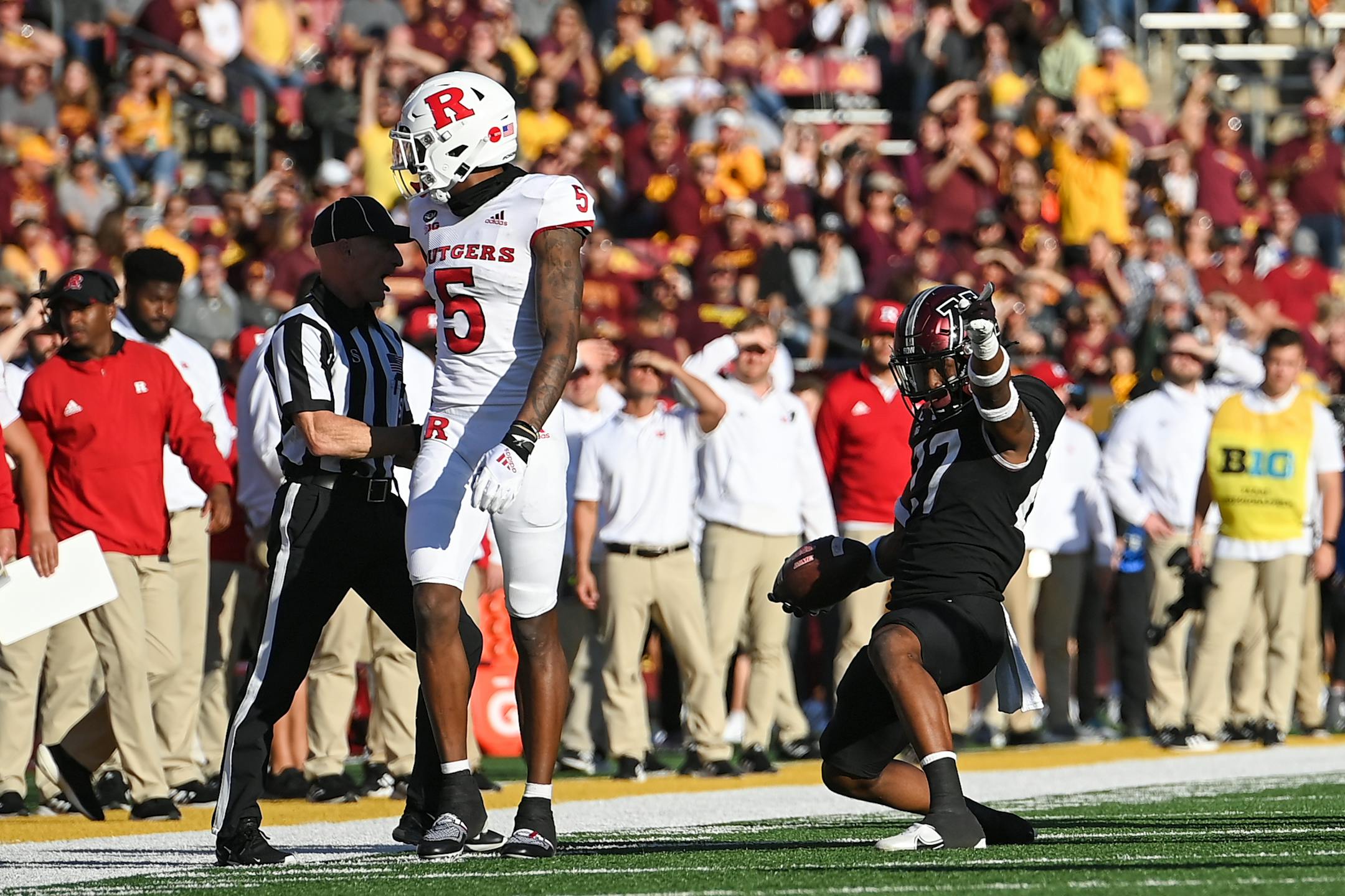 Minnesota Golden Gophers defensive back Tyler Nubin (27) celebrates his first fourth quarter interception as intended reciever Rutgers Scarlet Knights wide receiver Sean Ryan (5) looks on.