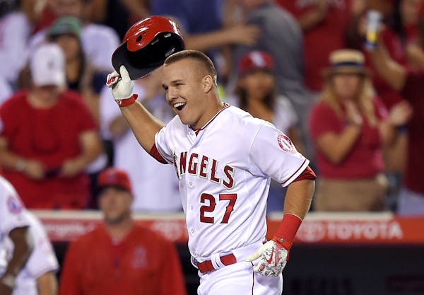 Los Angeles Angels' Mike Trout tosses his helmet as he heads home after hitting a solo walk off home run during the ninth inning of a baseball game ag