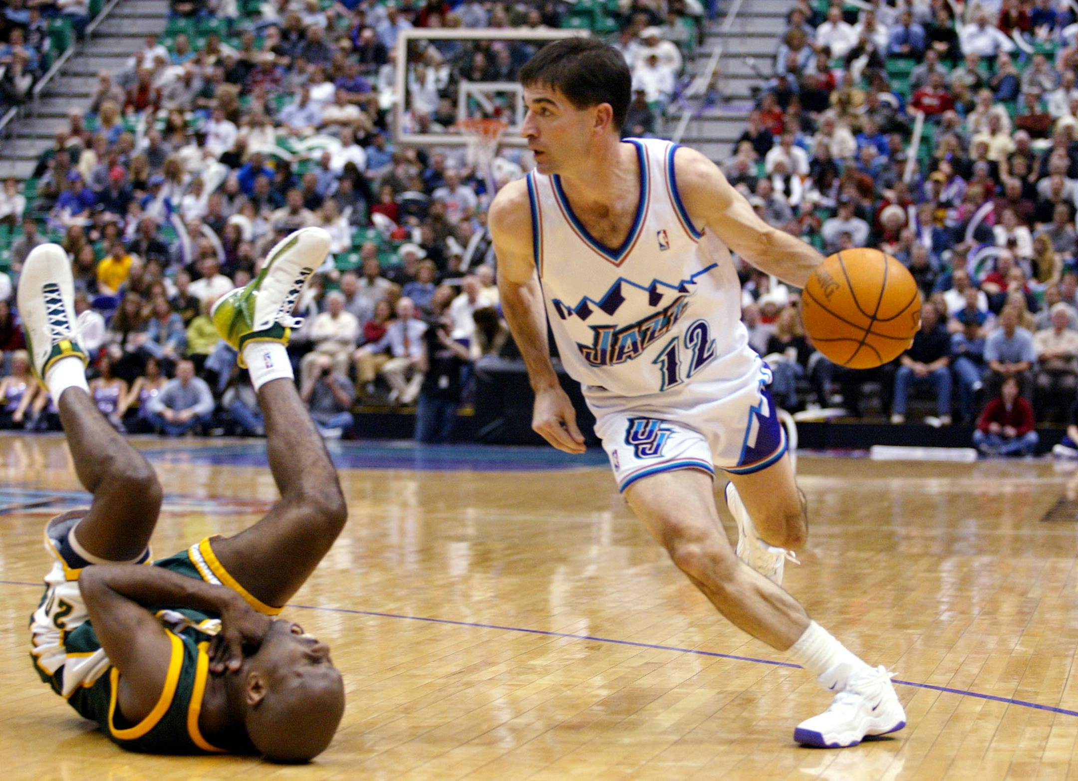 Seattle SuperSonics guard Gary Payton, left, falls back while gasping for air after Utah Jazz guard John Stockton, right, elbowed him in the throat before driving toward the basket during the second half Thursday, Jan. 16, 2003, in Salt Lake City. (AP Photo/Steve C. Wilson) ORG XMIT: SLCW105