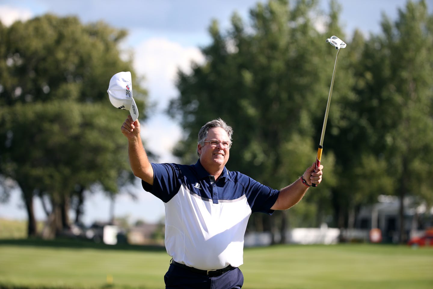 Kenny Perry raised his hands in victory Sunday after winning the 3M Championship at the TPC Twin Cities in Blaine. Perry became the first repeat winner in tournament history.