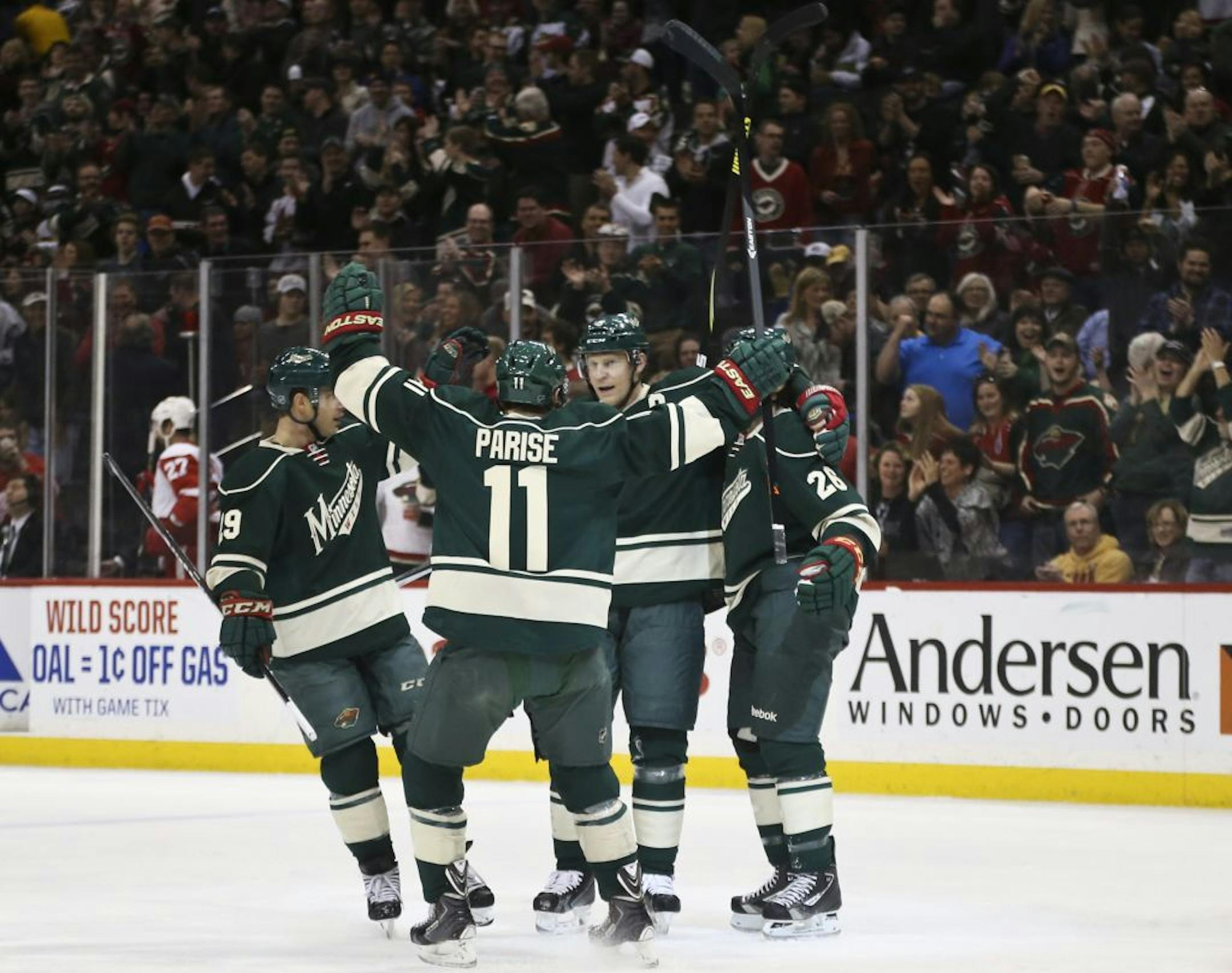 The Minnesota Wild's Zachary Parise (11) greets teammate Mikkoi Koivu (9) during the first period after Koivu scored against the Detroit Red Wings and became the Wild's all-time leading scorer at the Xcel Energy Center, Saturday, March 22, 2014.