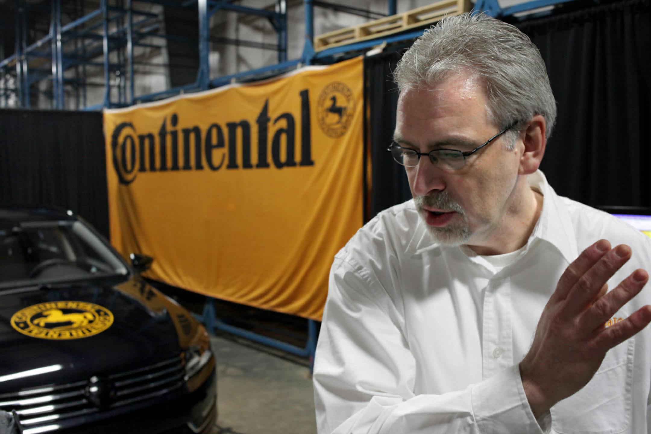 Dave Agnew of Systems Engineering talks about technology involved in building an autonomous car, pictured behind him, at the Continental development center in Brimley, Mich. (Kimberly P. Mitchell/Detroit Free Press/MCT)