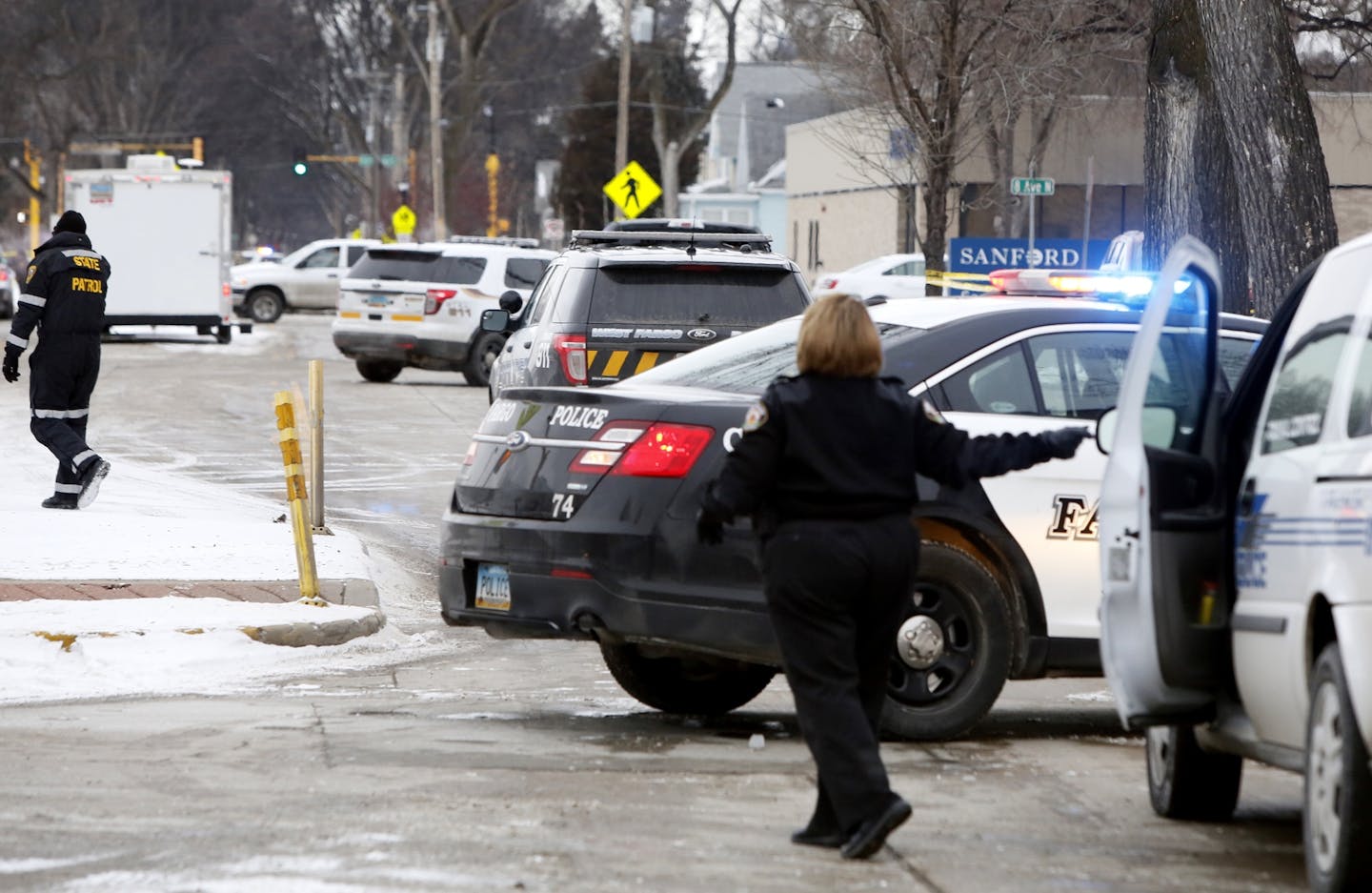 Law enforcement vehicles line Fourth Street North on Thursday, Feb. 11, 2016, near the scene of a police shooting the night before in Fargo. Michael Vosburg / Forum Photo Editor