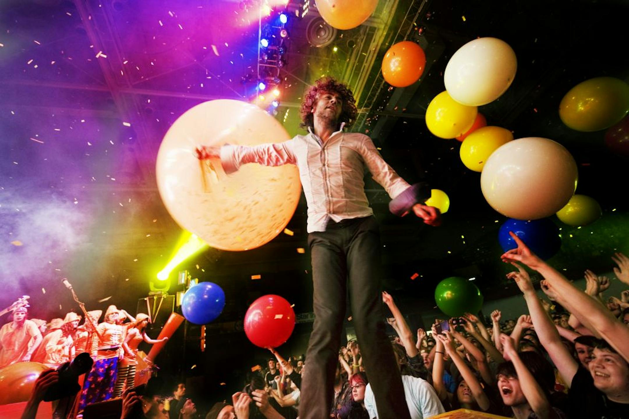 Wayne Coyne of the Flaming Lips throws balloons to his fans during his Sunday evening performance at the Roy Wilkins Auditorium in St.Paul.