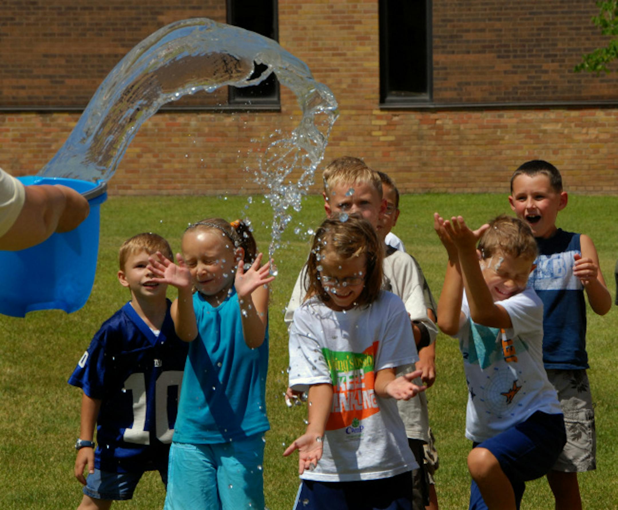 The youngest campers at Camp Invention cool off with a splash of water after a game of "Little Squirts" during recess remix. Camp Invention is a national, nonprofit science enrichment program from the National Inventors Hall of Fame Foundation with the United States Patent and Trademark Office.