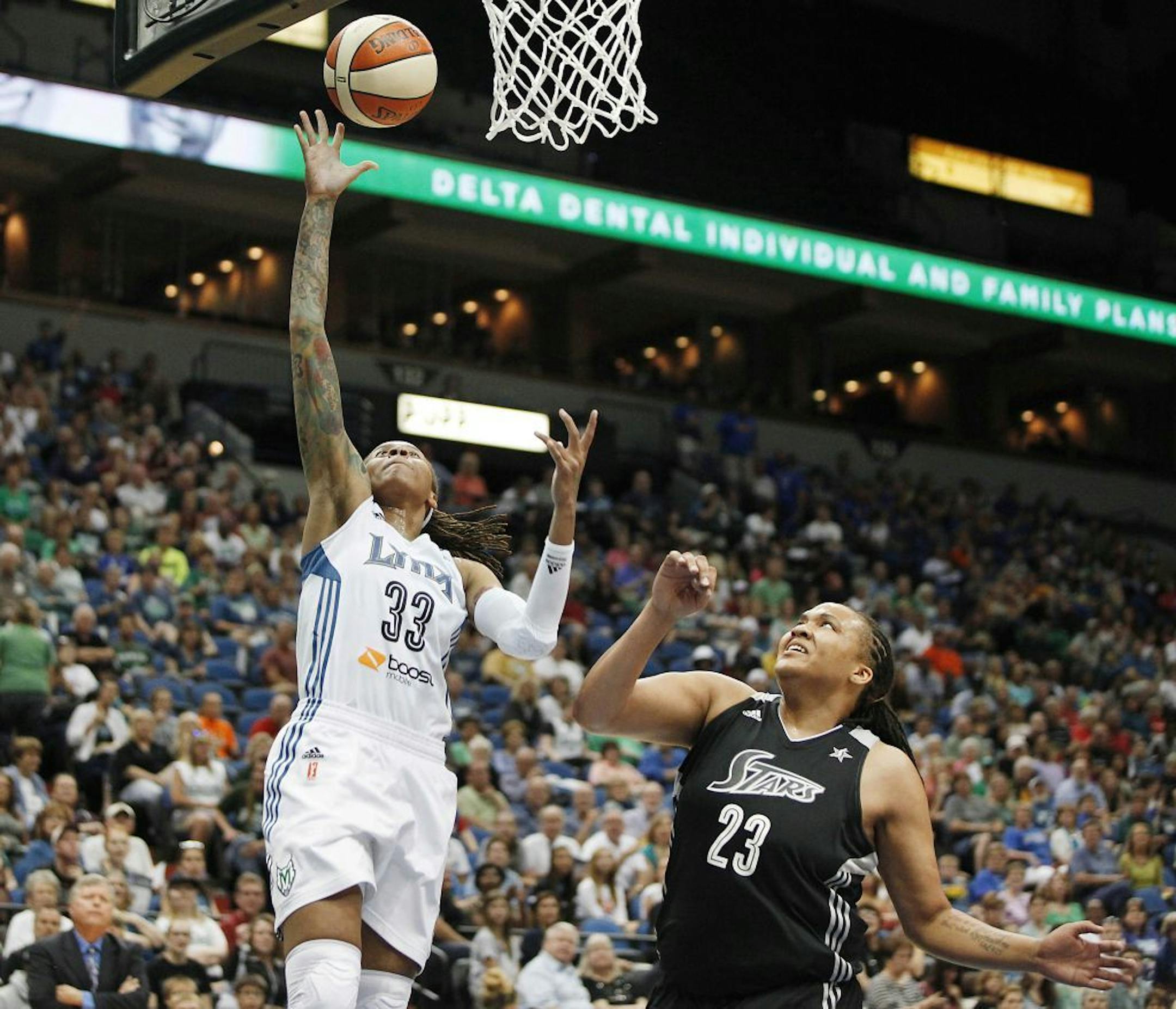 Lynx guard Seimone Augustus drove to the basket past San Antonio forward Danielle Adams during the first half at Target Center on Friday.