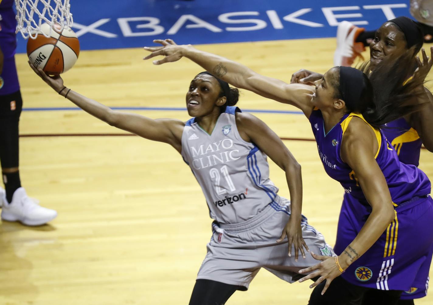 Minnesota Lynx guard Renee Montgomery (21) shoots as Los Angeles Sparks forward Candace Parker (3), right front, defends during Game 2 of the WNBA finals, Tuesday, Sept. 26, 2017, in Minneapolis. (Renee Jones Schneider/Star Tribune via AP)